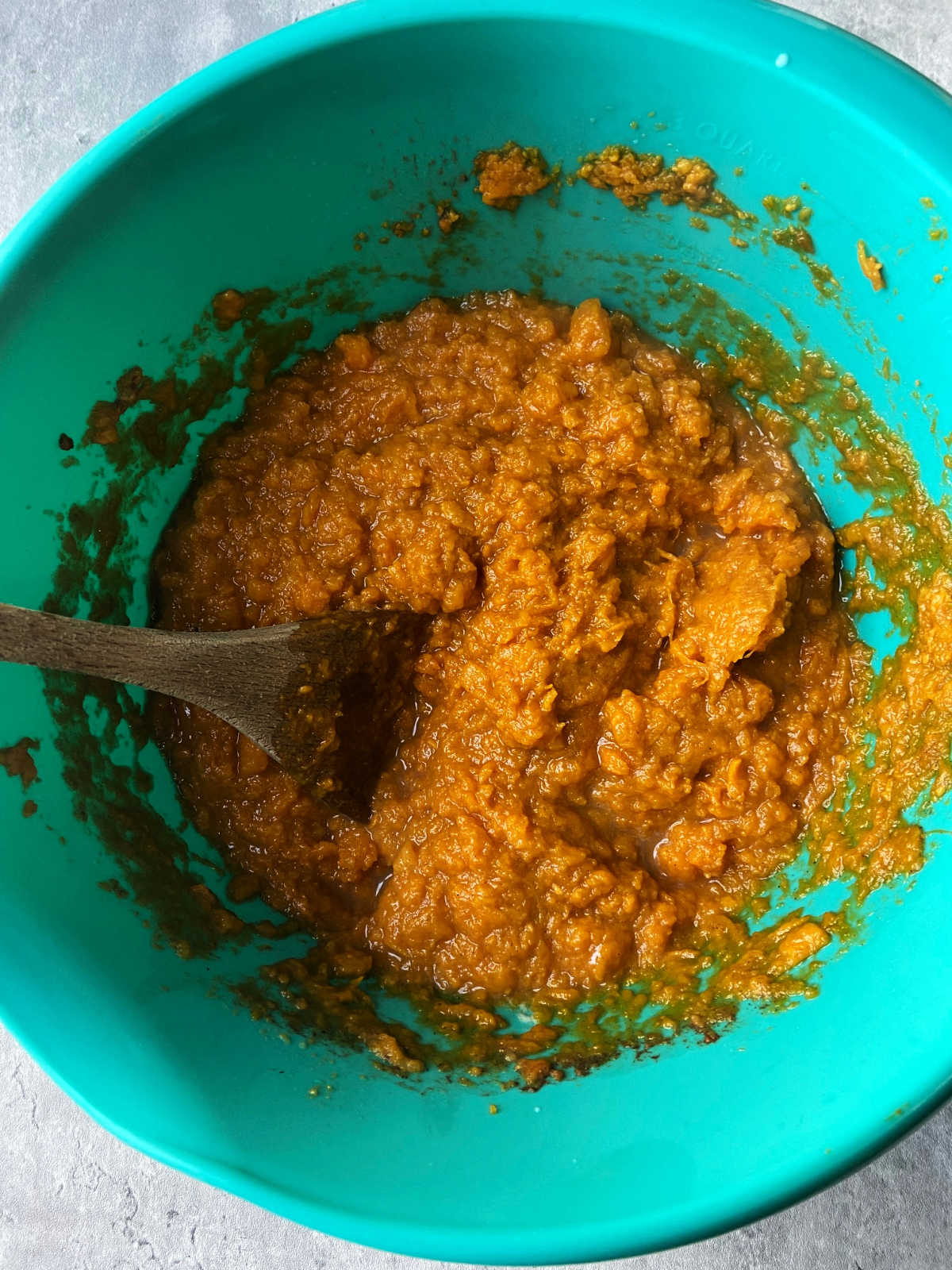 Mashed sweet potatoes in a blue bowl. 