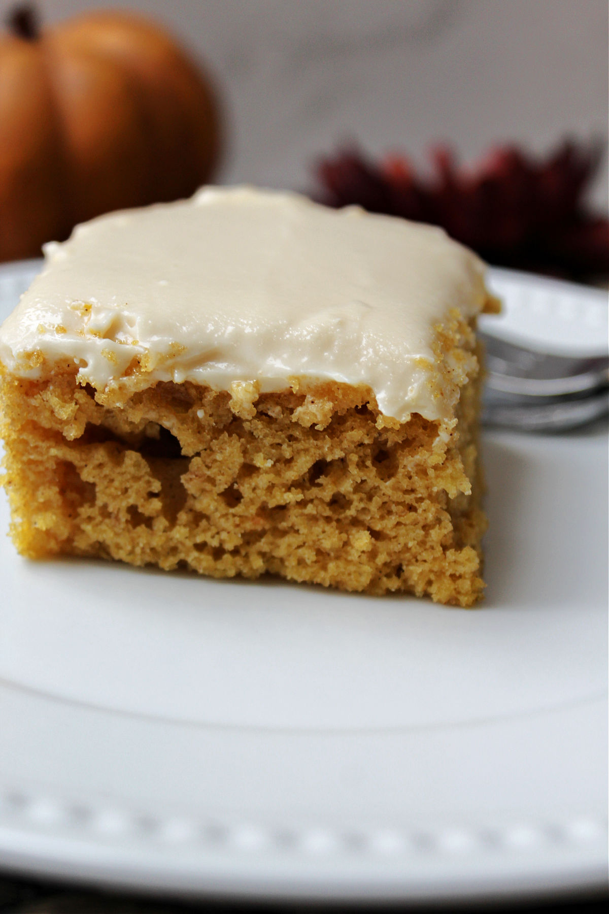 Pumpkin bar slice on white plate. 