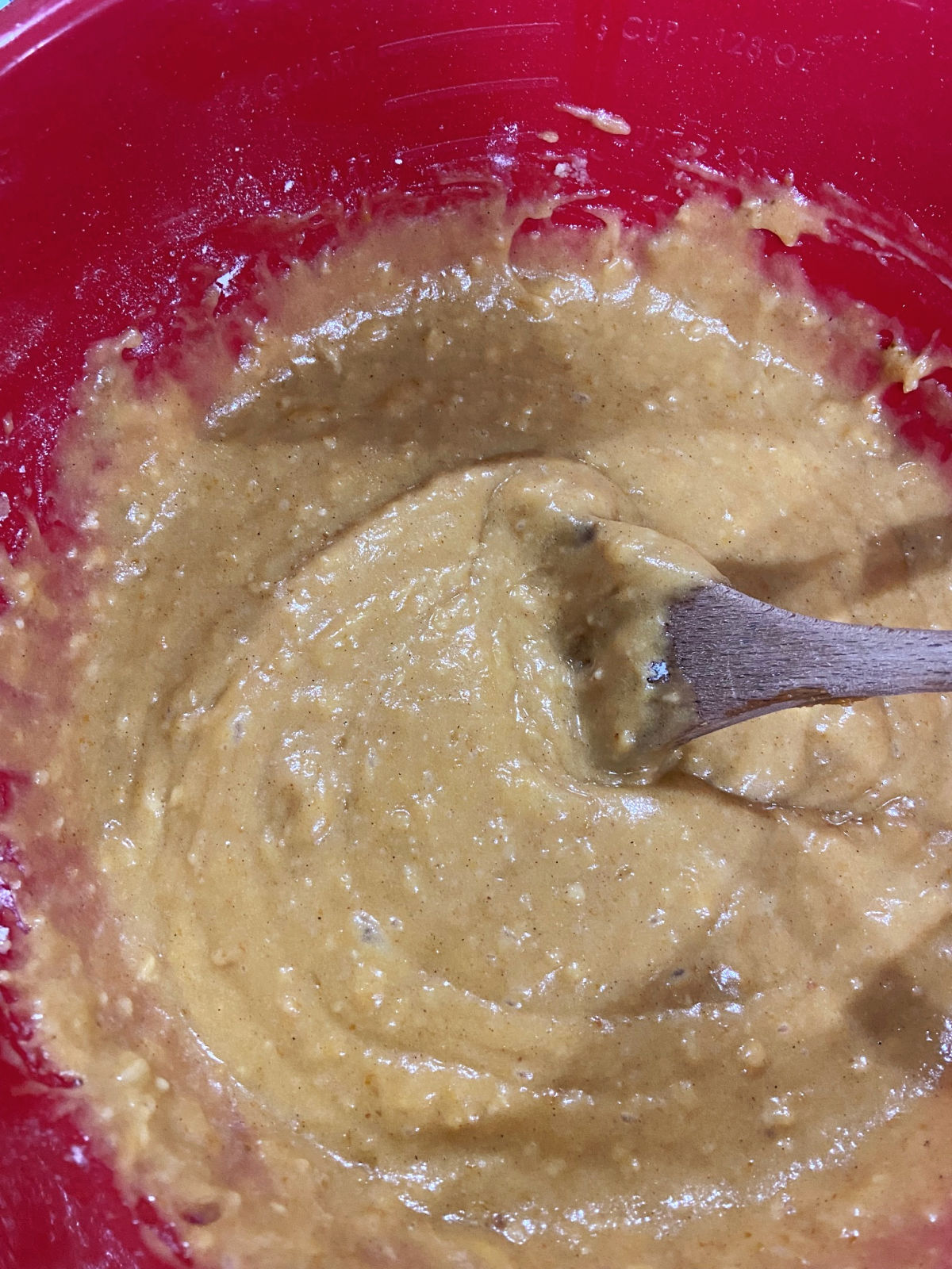 Mixed pumpkin bars batter in a red bowl. 