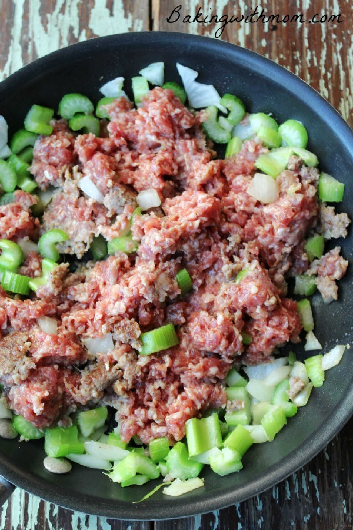 Sausage, celery and onion in a frying pan.