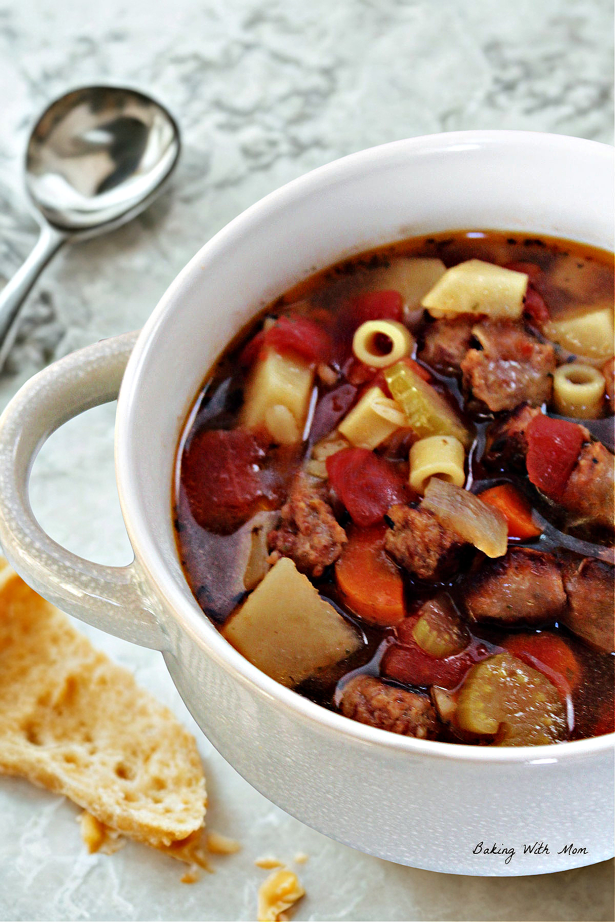 sausage soup in a white bowl. 