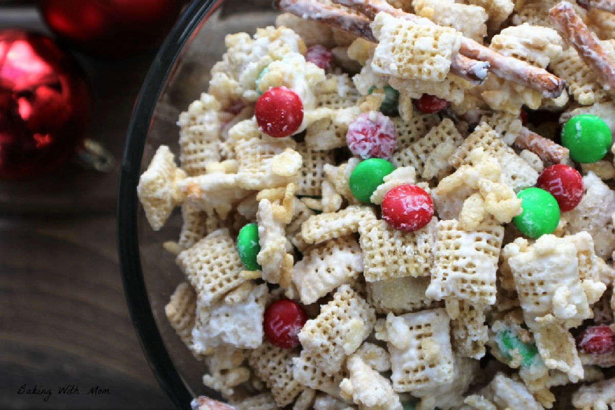 Christmas Mix in a clear bowl with ornaments nearby