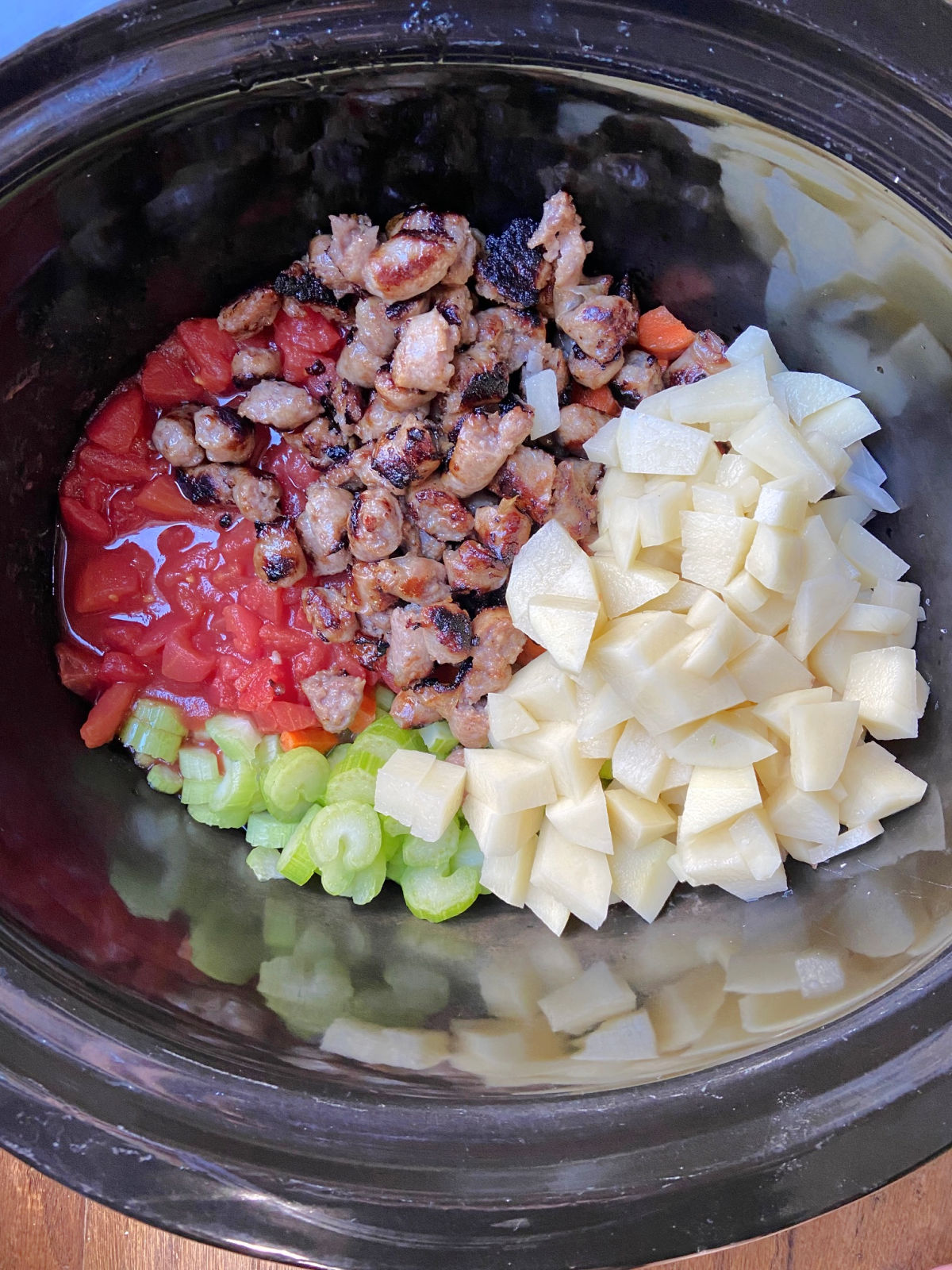 vegetables in a crock pot ready to be cooked for the soup.