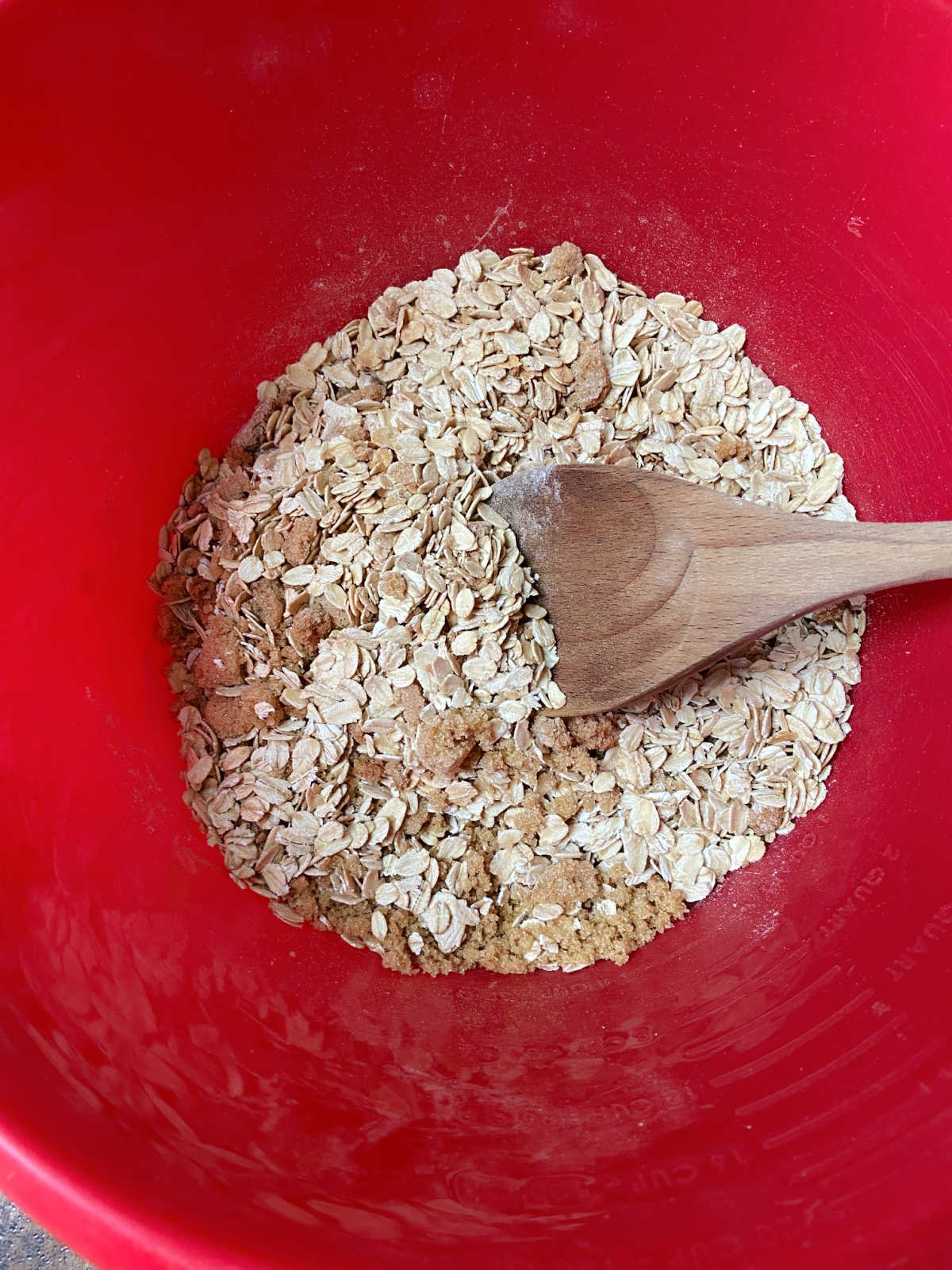 Dry ingredients for the oatmeal bake in a red bowl. 