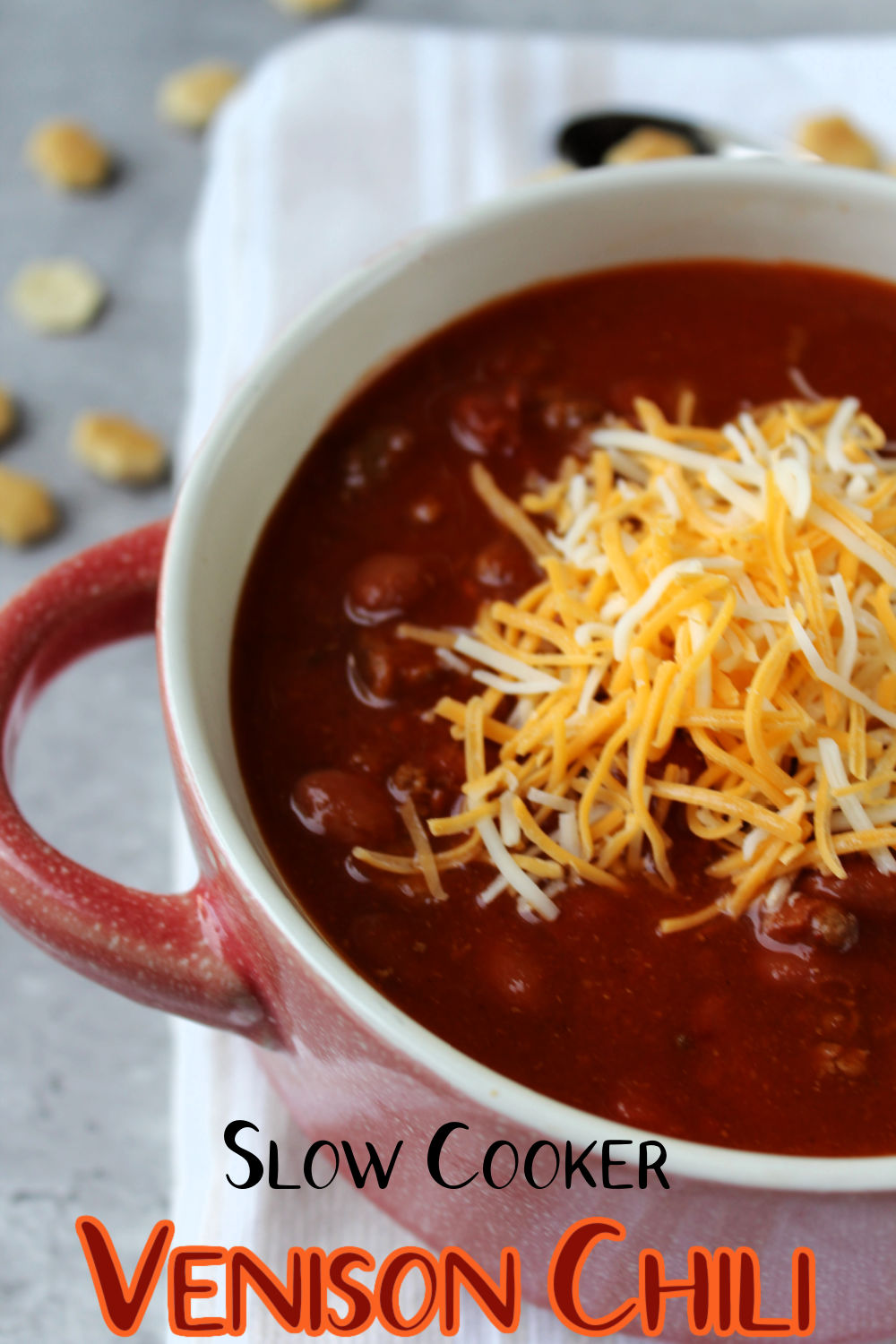 chili in a bowl with sprinkled cheese on top. 