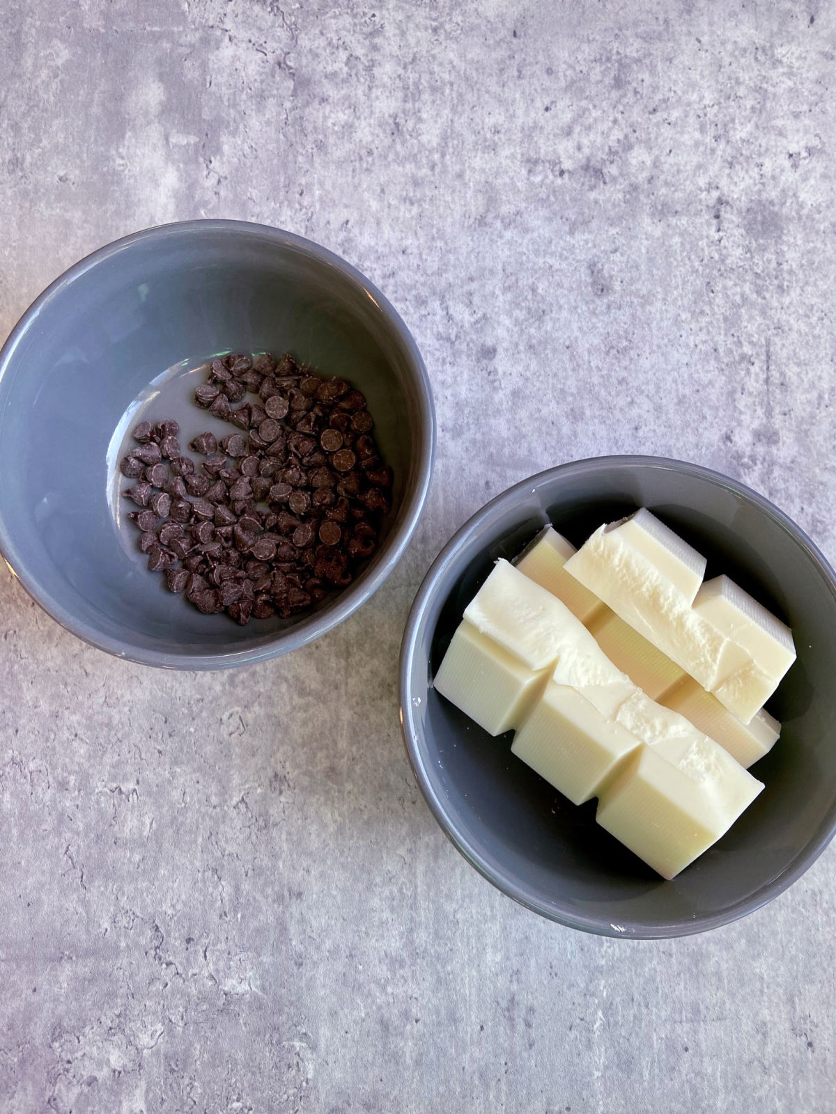 almond bark and chocolate in separate gray bowls.