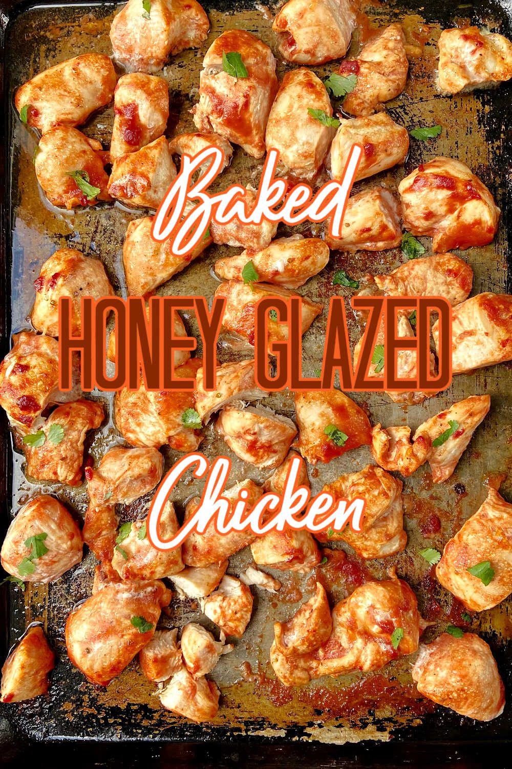 Baked chicken with a honey glaze pieces on a baking sheet. 