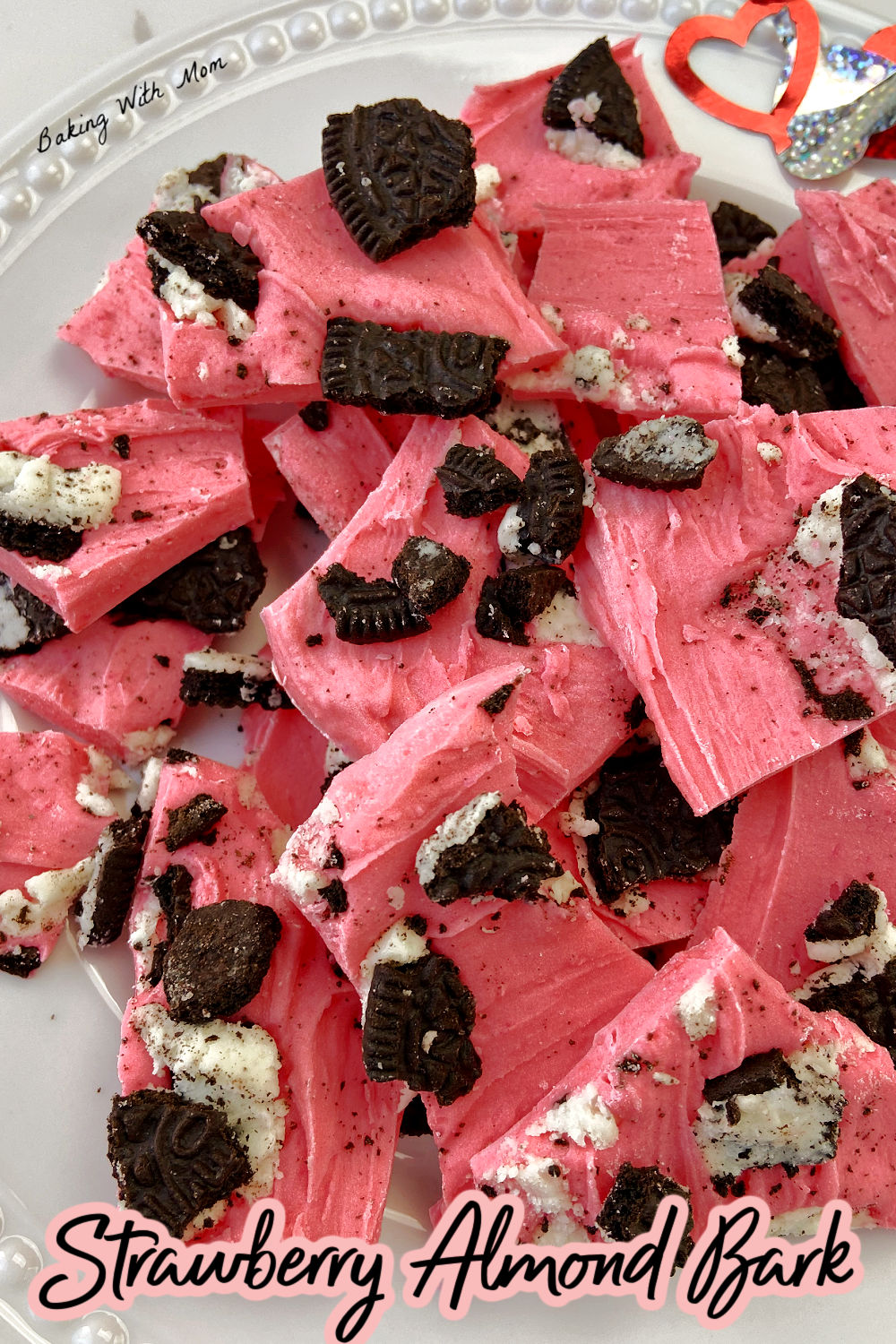 Strawberry almond bark on a white plate. 