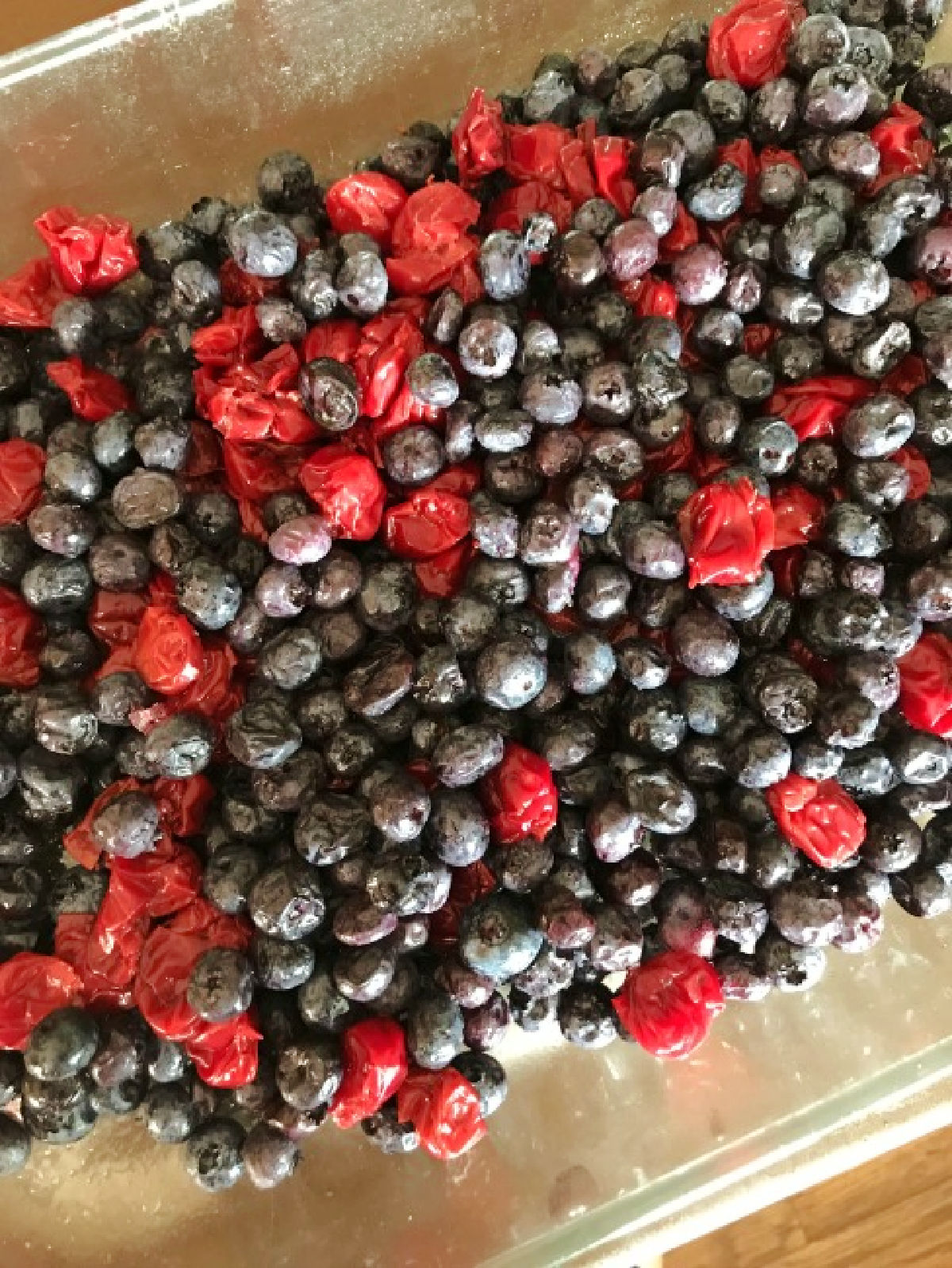 blueberries and cherries in a baking dish. 