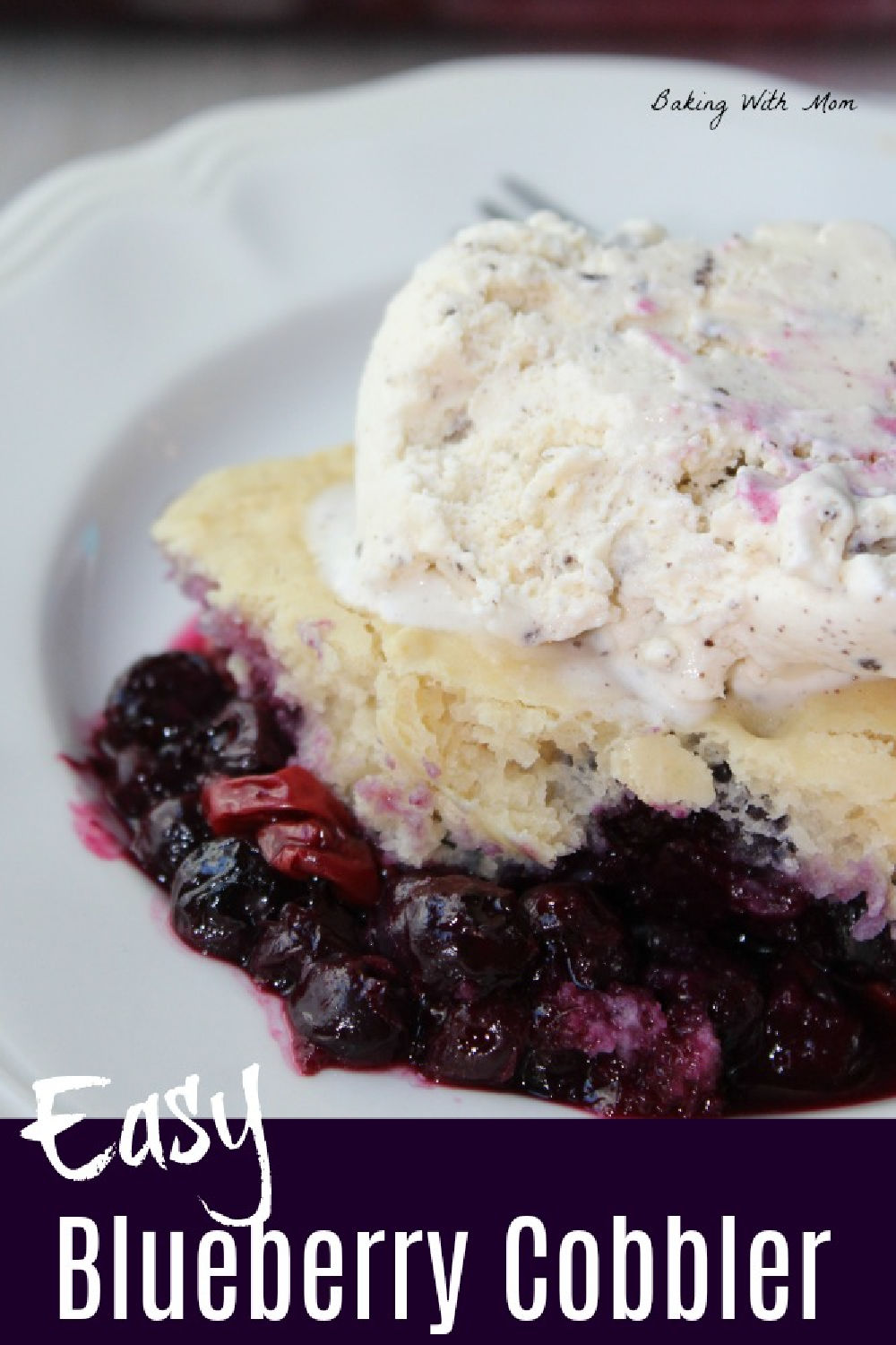 Easy blueberry cobbler on a white plate with a scoop of ice cream on top. 