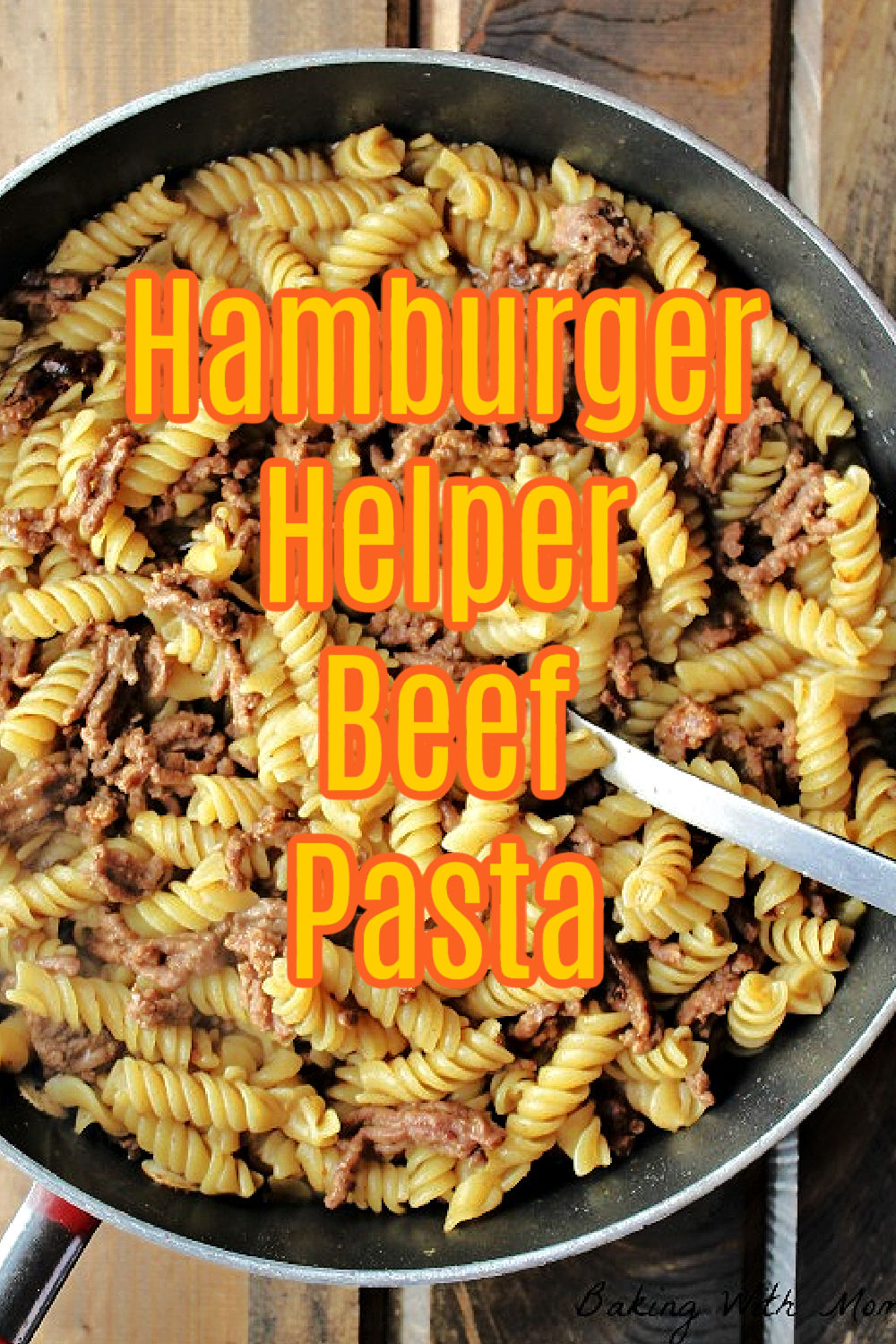 noodles, hamburger in a frying pan with a silver spoon. 