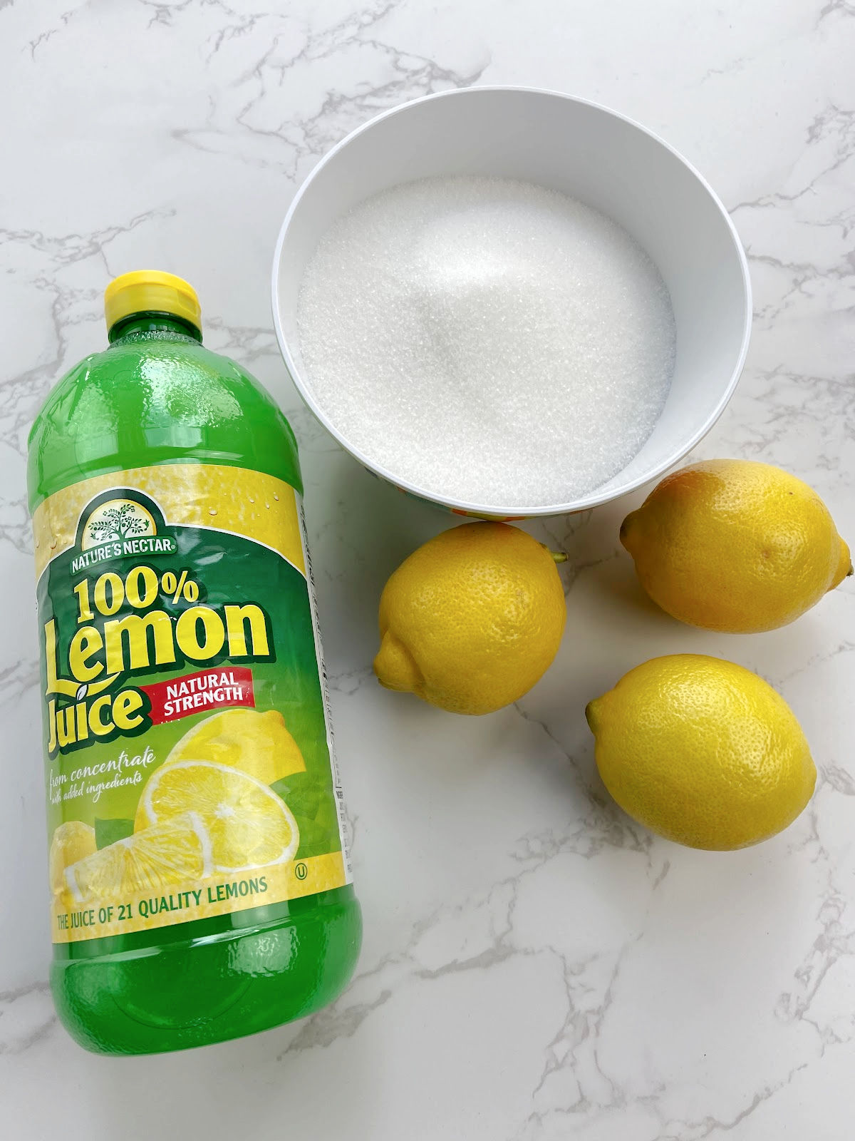 lemons, bottle of lemon juice and sugar.