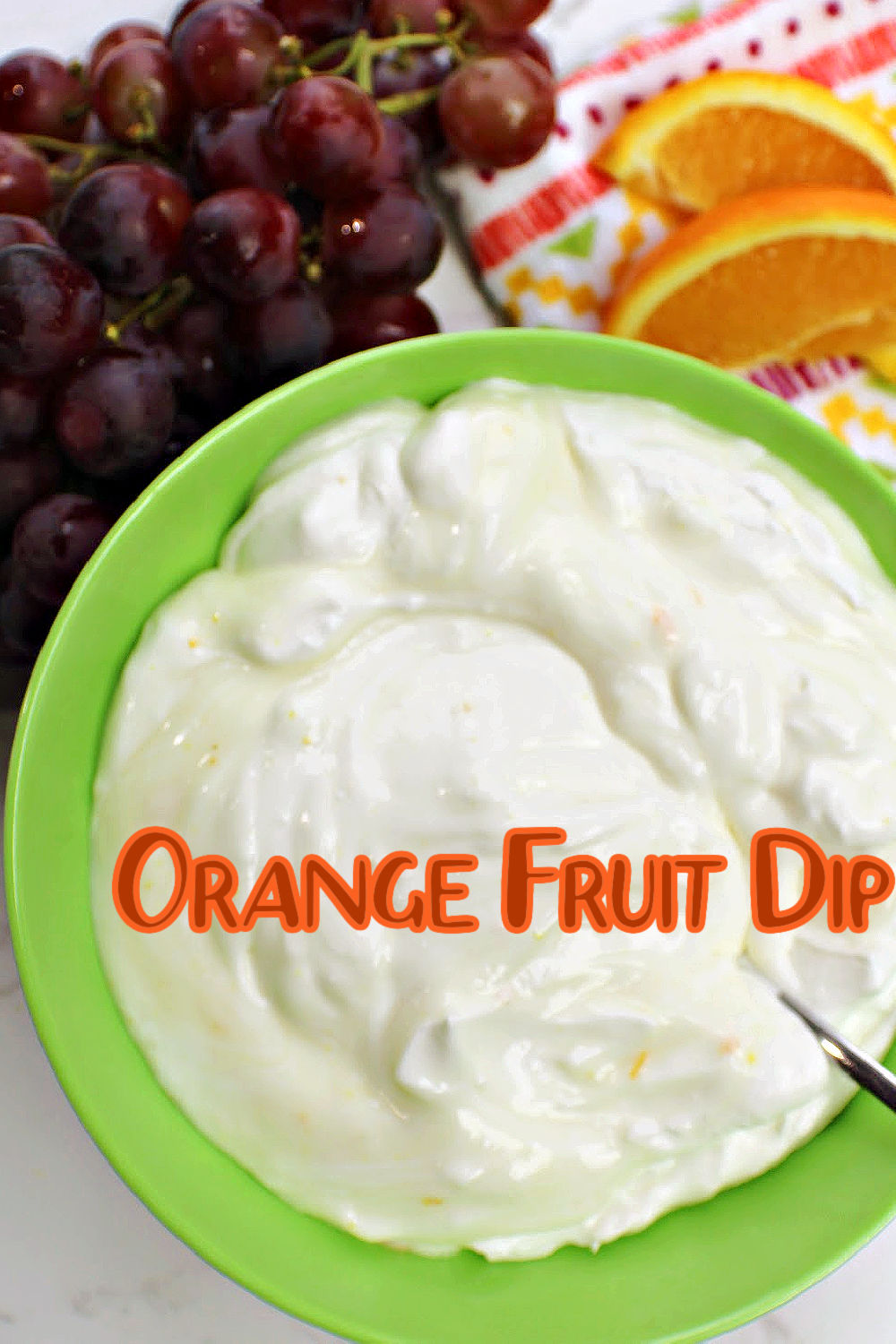 Close up of orange fruit dip in a green bowl. 