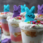 Peeps parfait with peeps marshmallow and sprinkles in plastic cups.