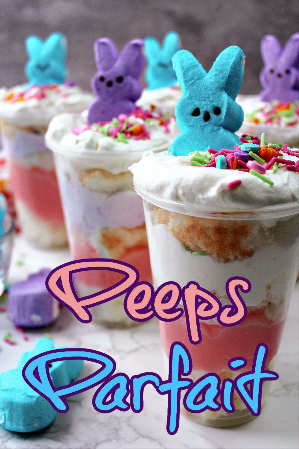 Close up of peeps parfait with with Peeps marshmallows and sprinkles laying besides. 