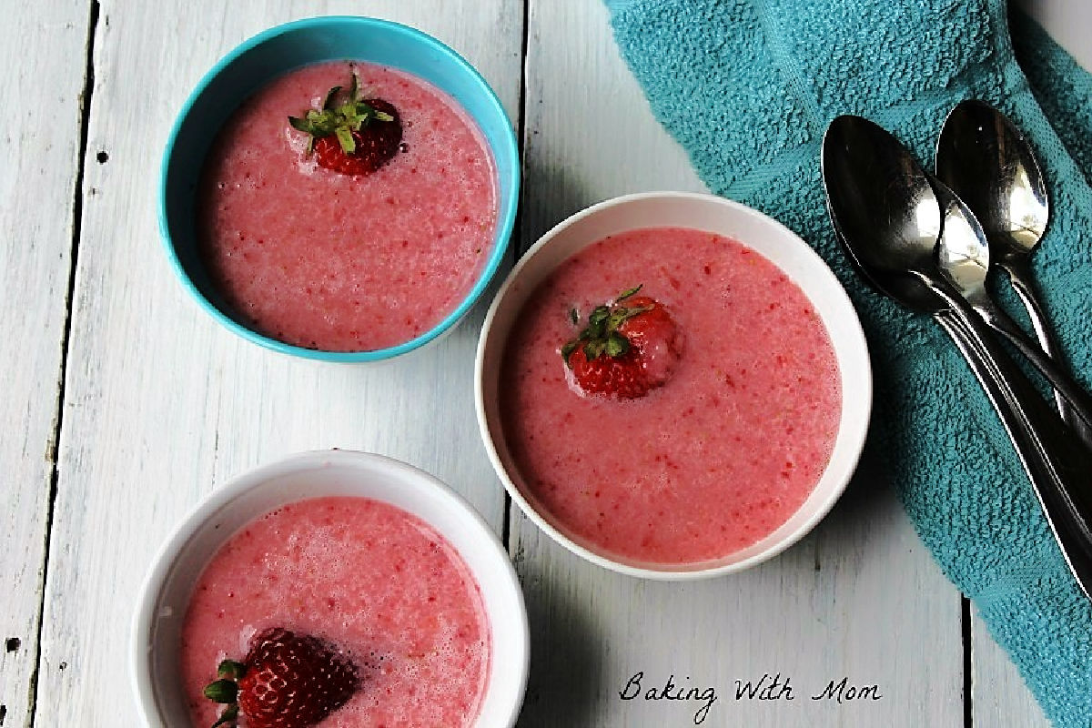 Strawberry soup in bowls with a strawberry in the middle. 