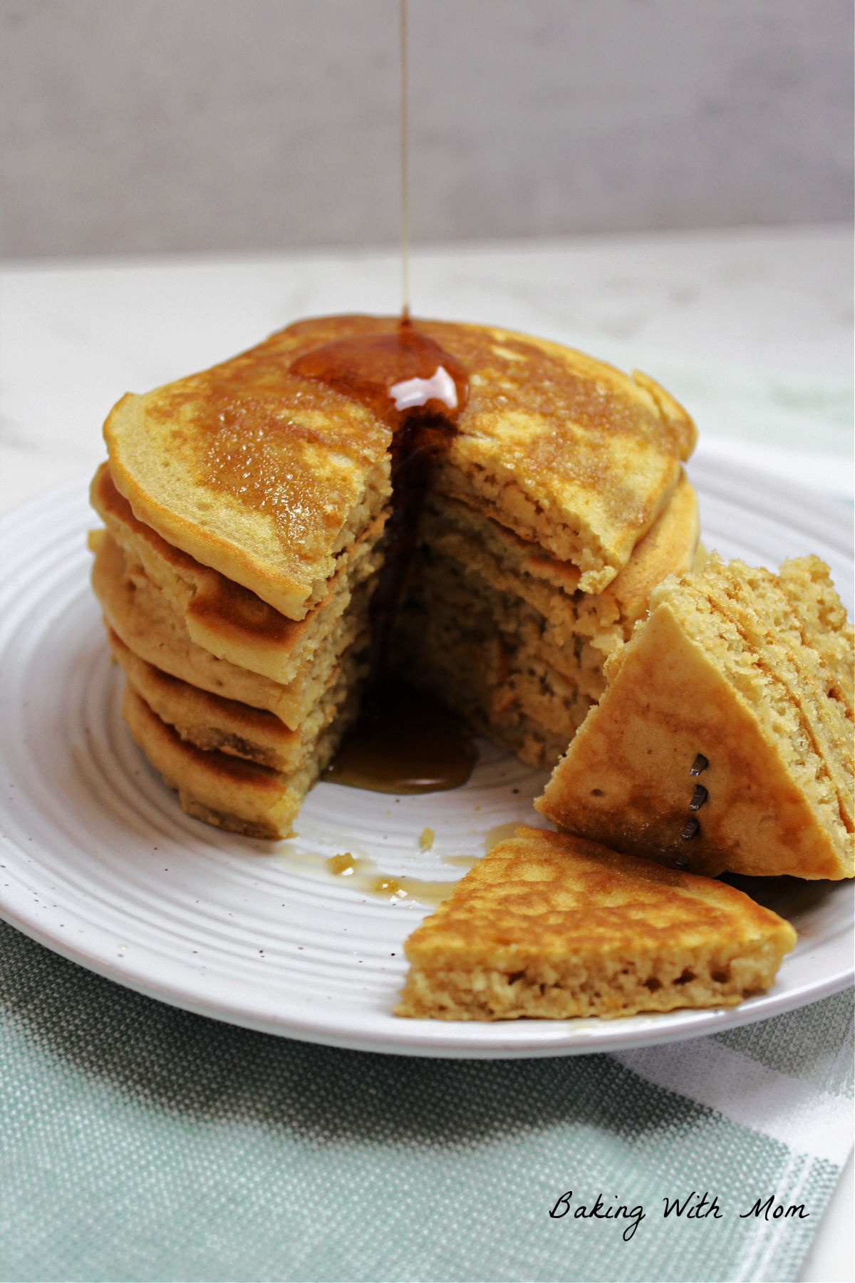 stack of pancakes on a white plate with a fork. 