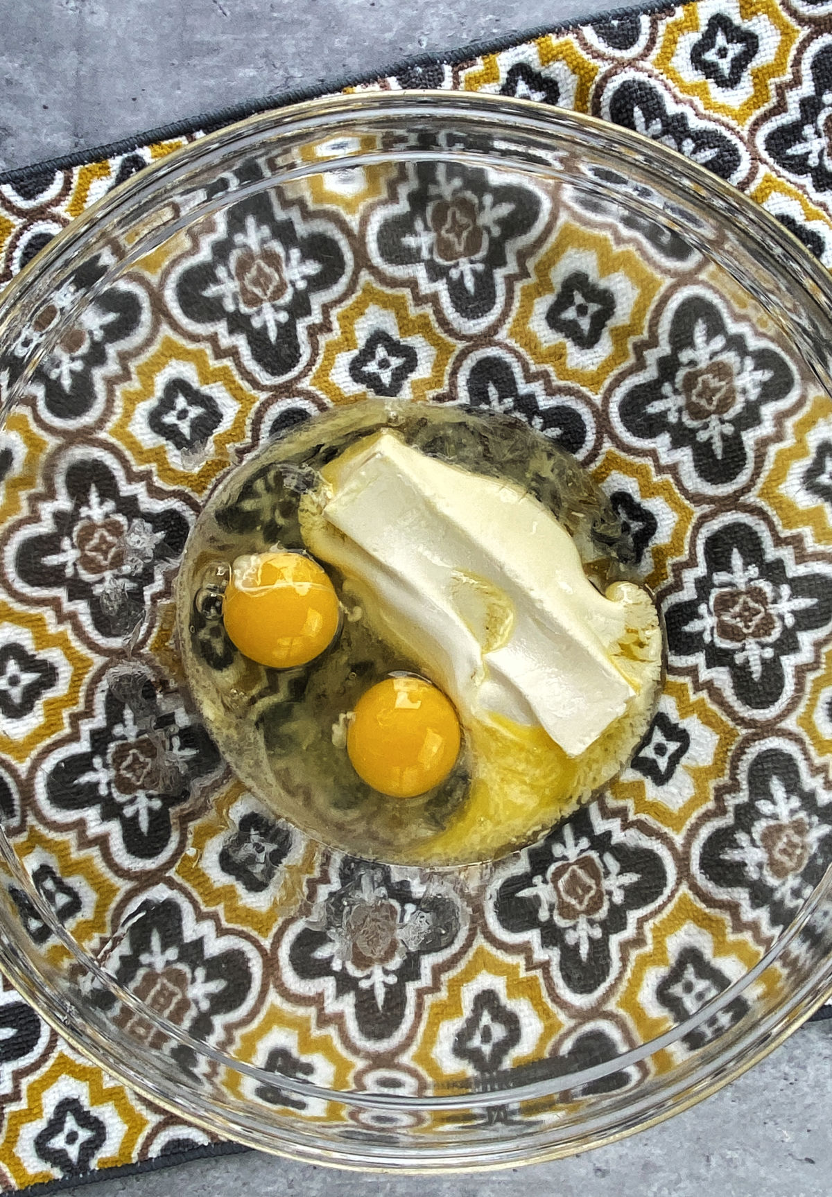 butter and eggs in a the bottom of a clear bowl. 