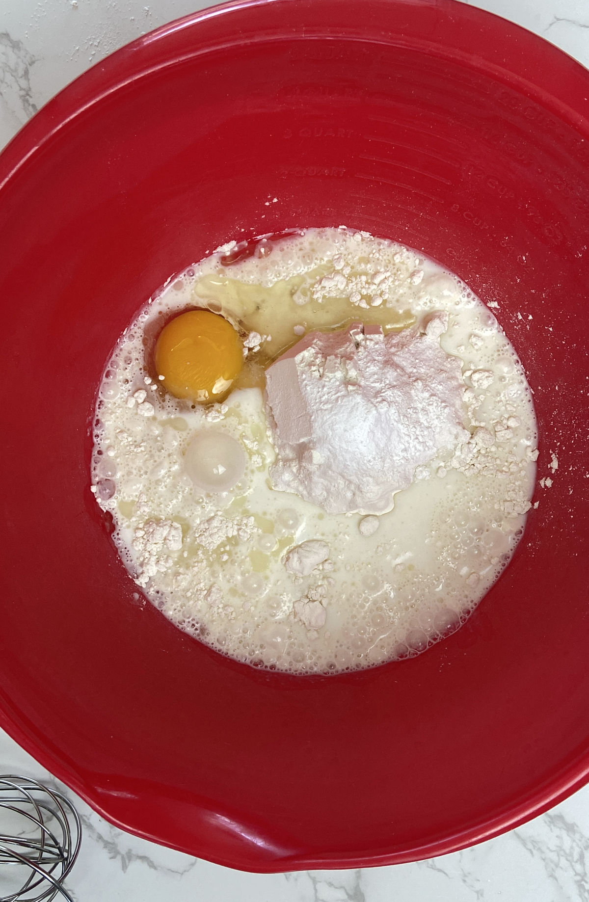 pancake ingredients in a red bowl. 