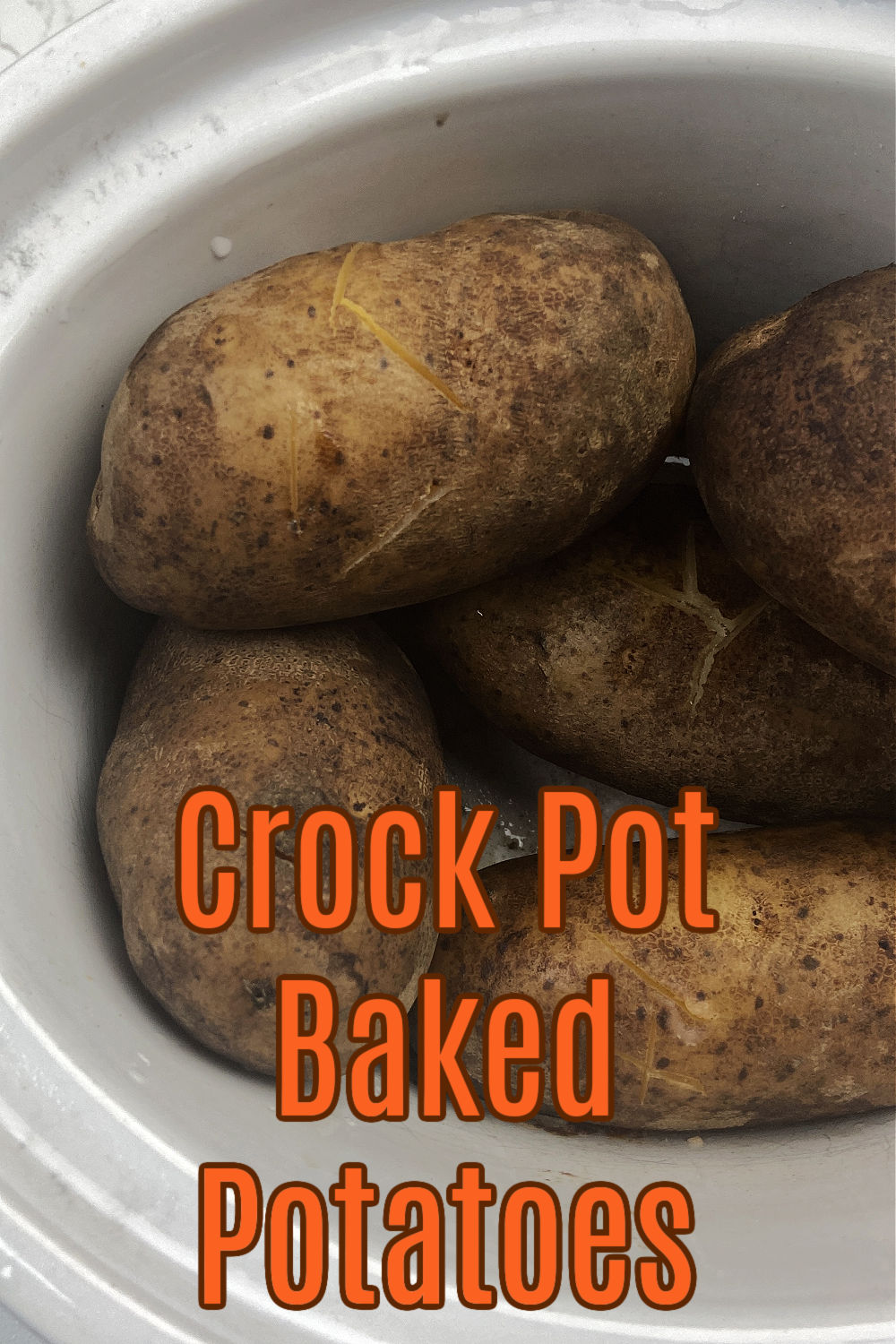 Baked potatoes in a white crock pot. 