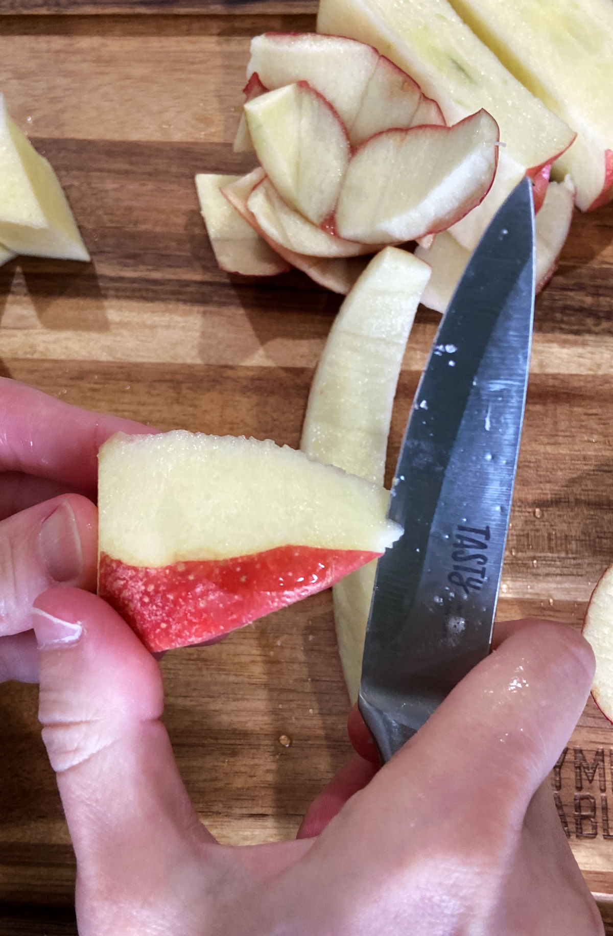 Hand holding an apple being peeled. 