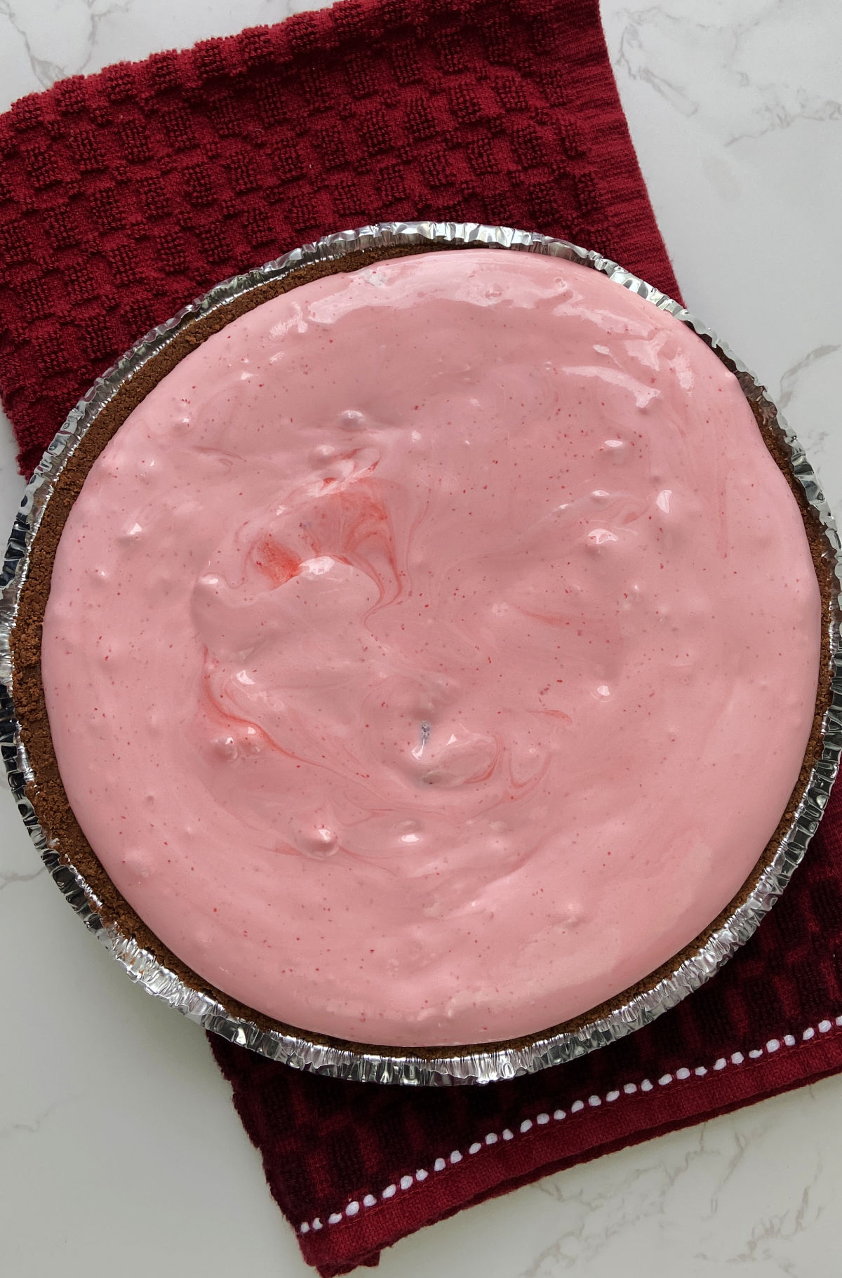 No bake strawberry pie on a red towel. 