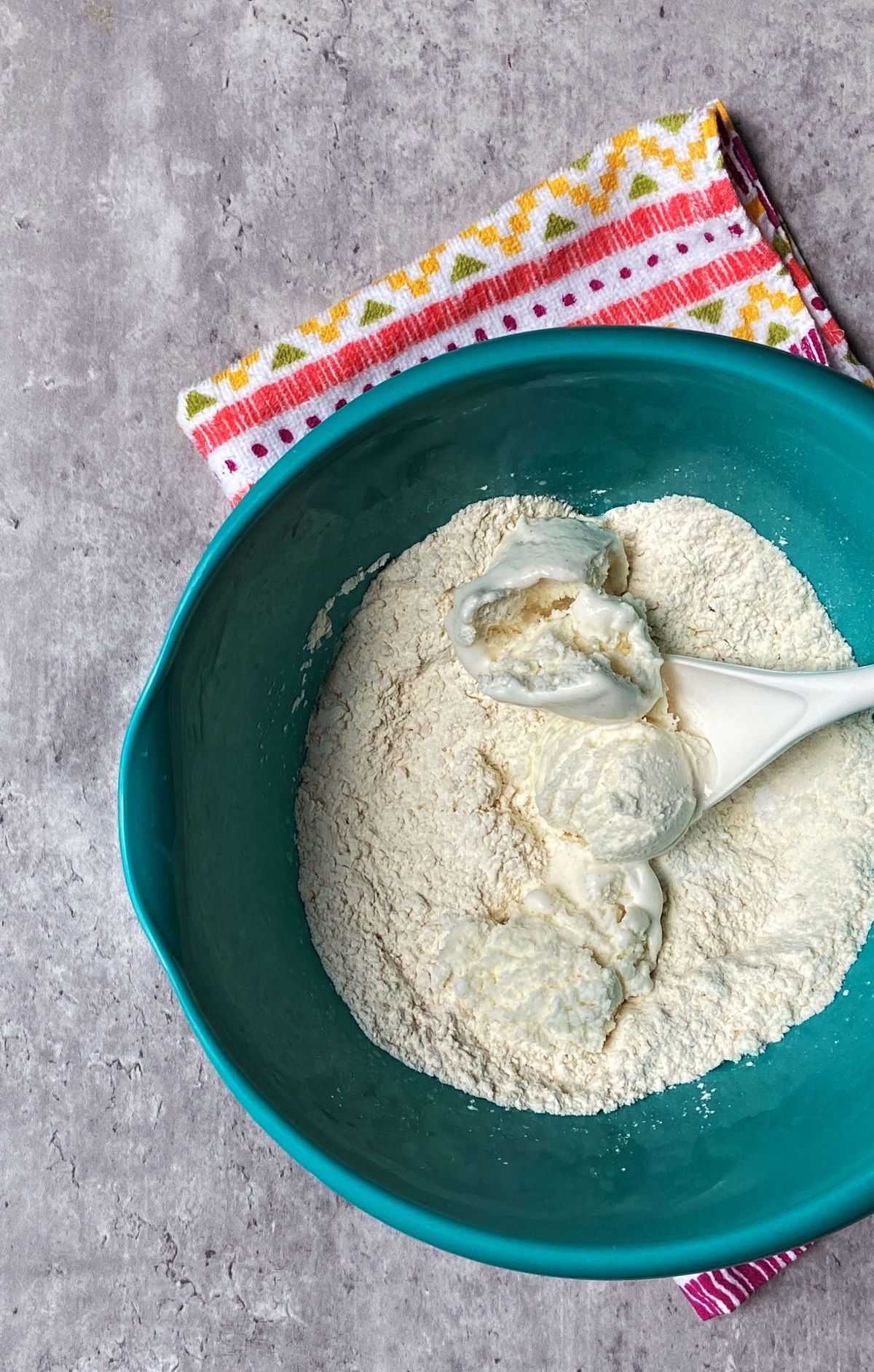 Ice cream in a flour mixture in a blue bowl. 