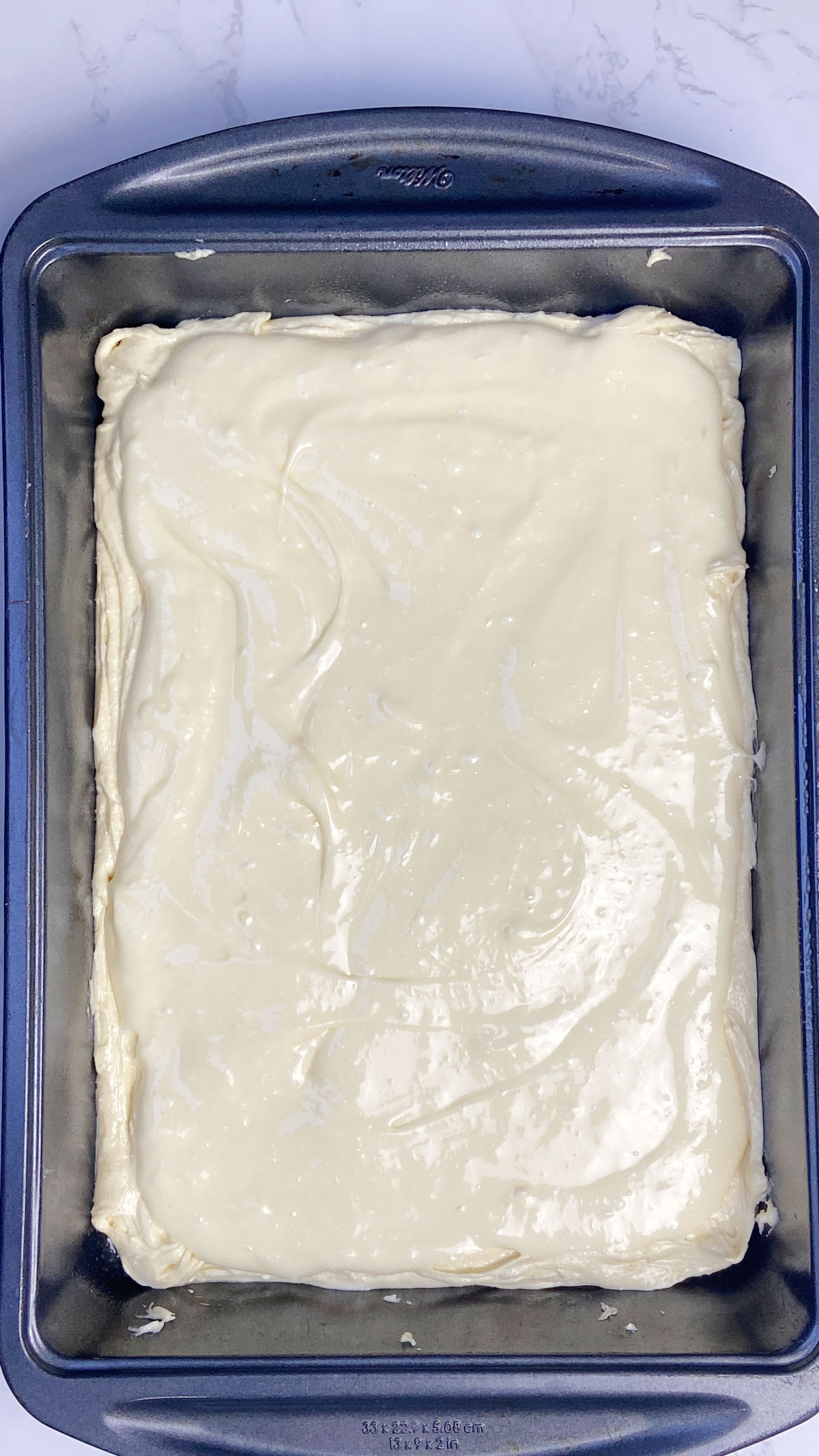 butter cake batter in a cake pan.
