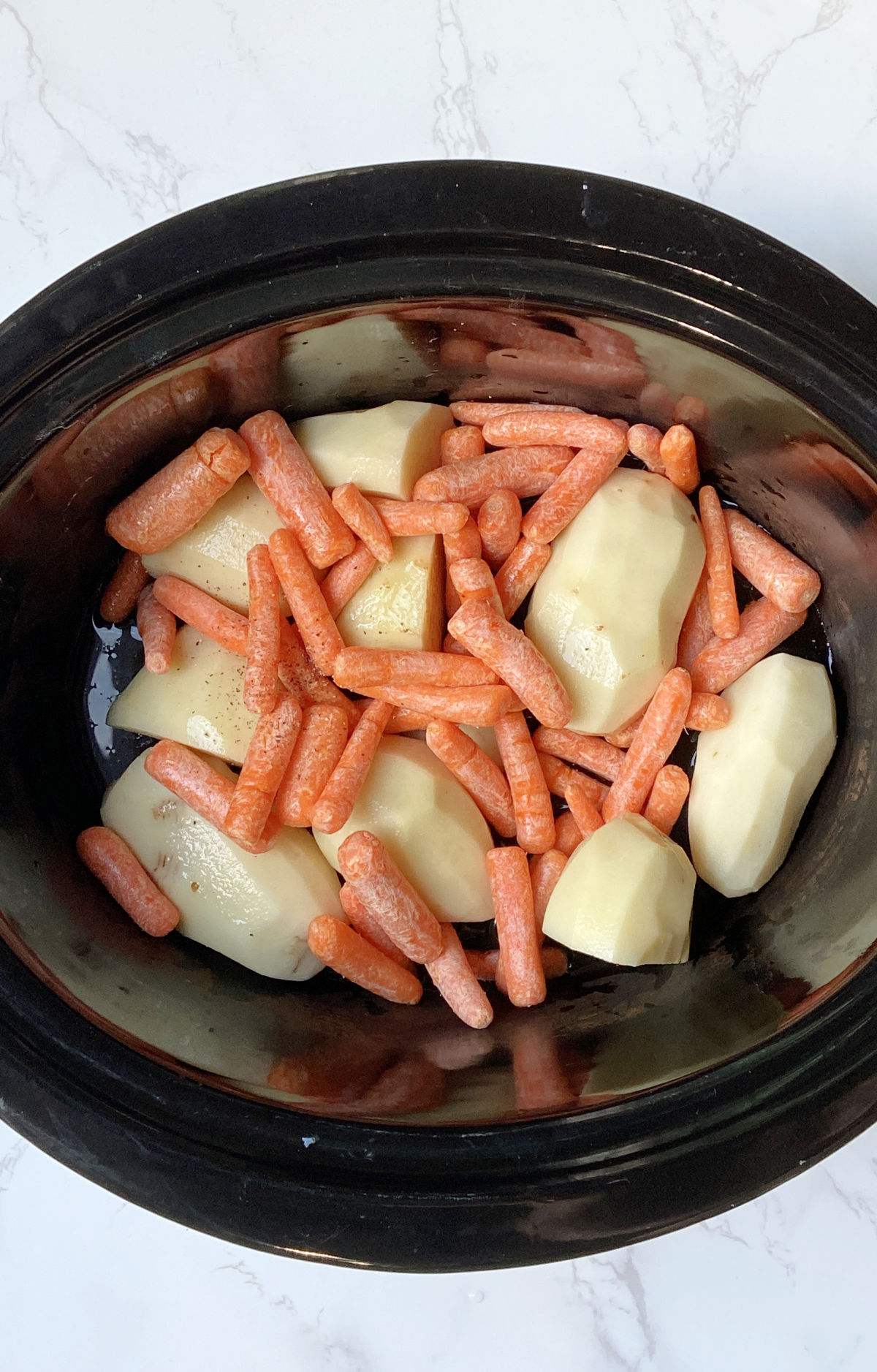 Potatoes and carrots in a crock pot. 