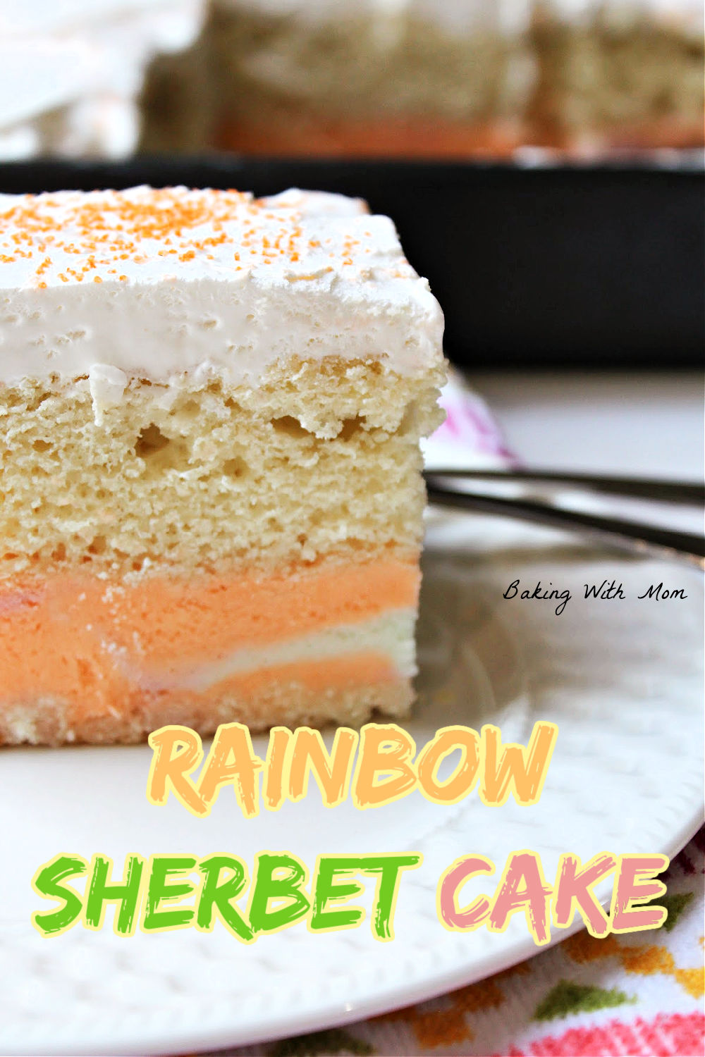 Slice of sherbet cake on a white plate with a cake pan behind. 