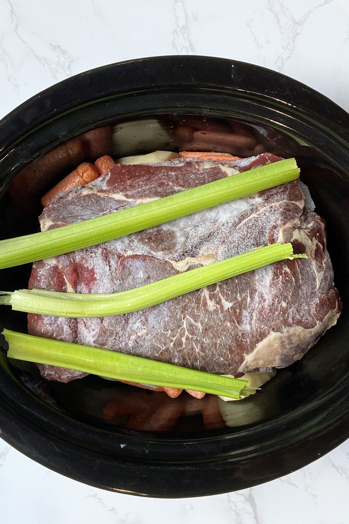 roast in a crock pot with celery on top. 