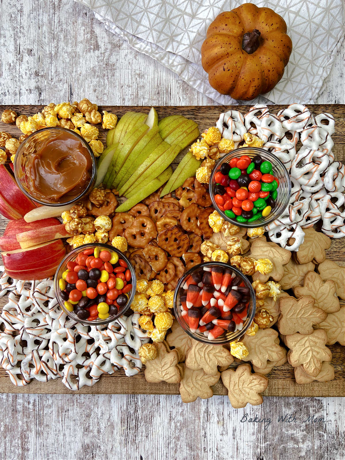 fall charcuterie board with pretzels and apples. 