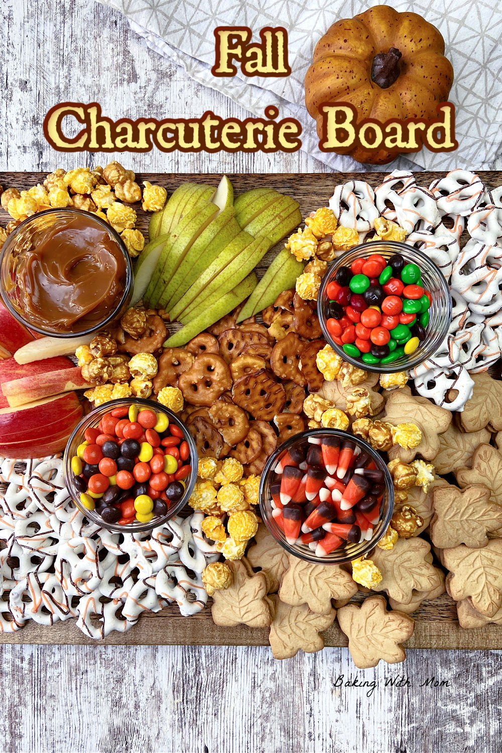 fall charcuterie board with fruit, pretzels and cookies. 