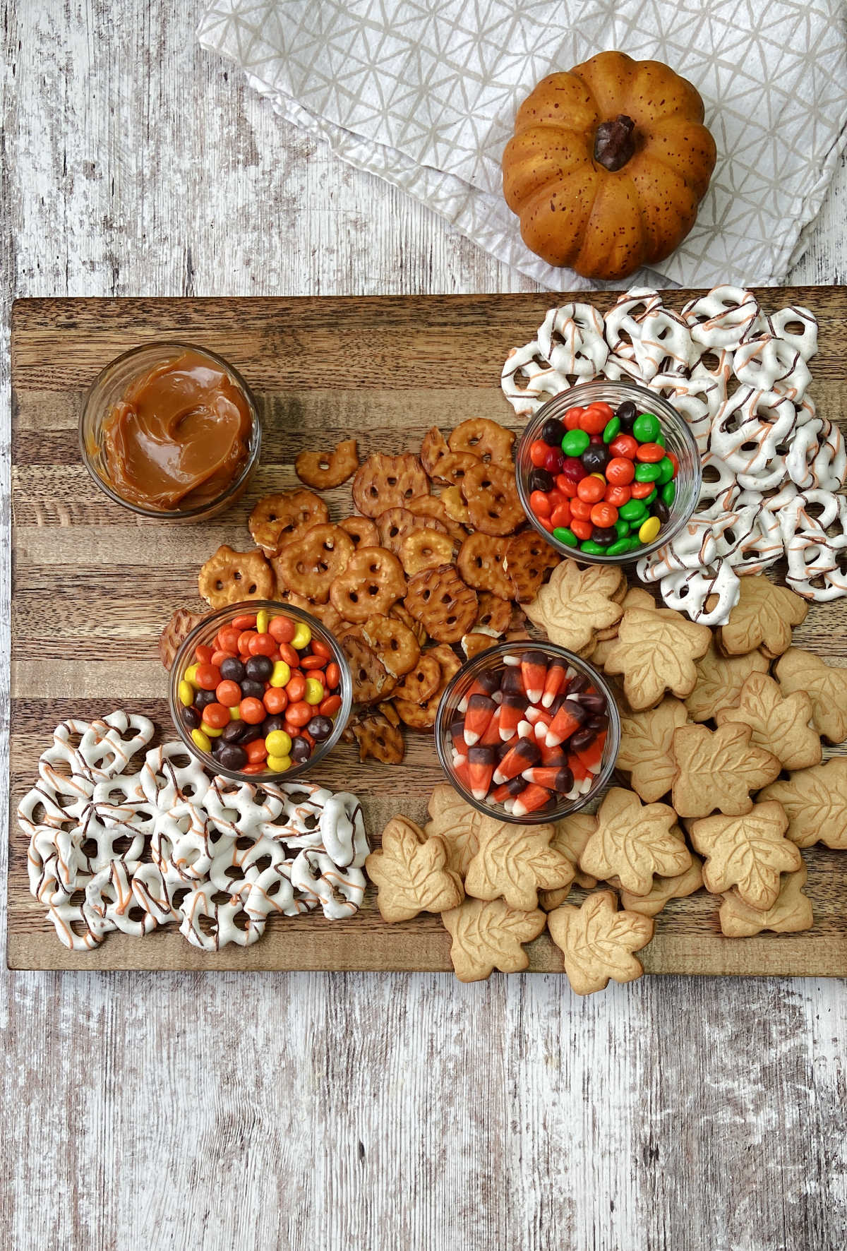 pretzels and candies on a brown board. 