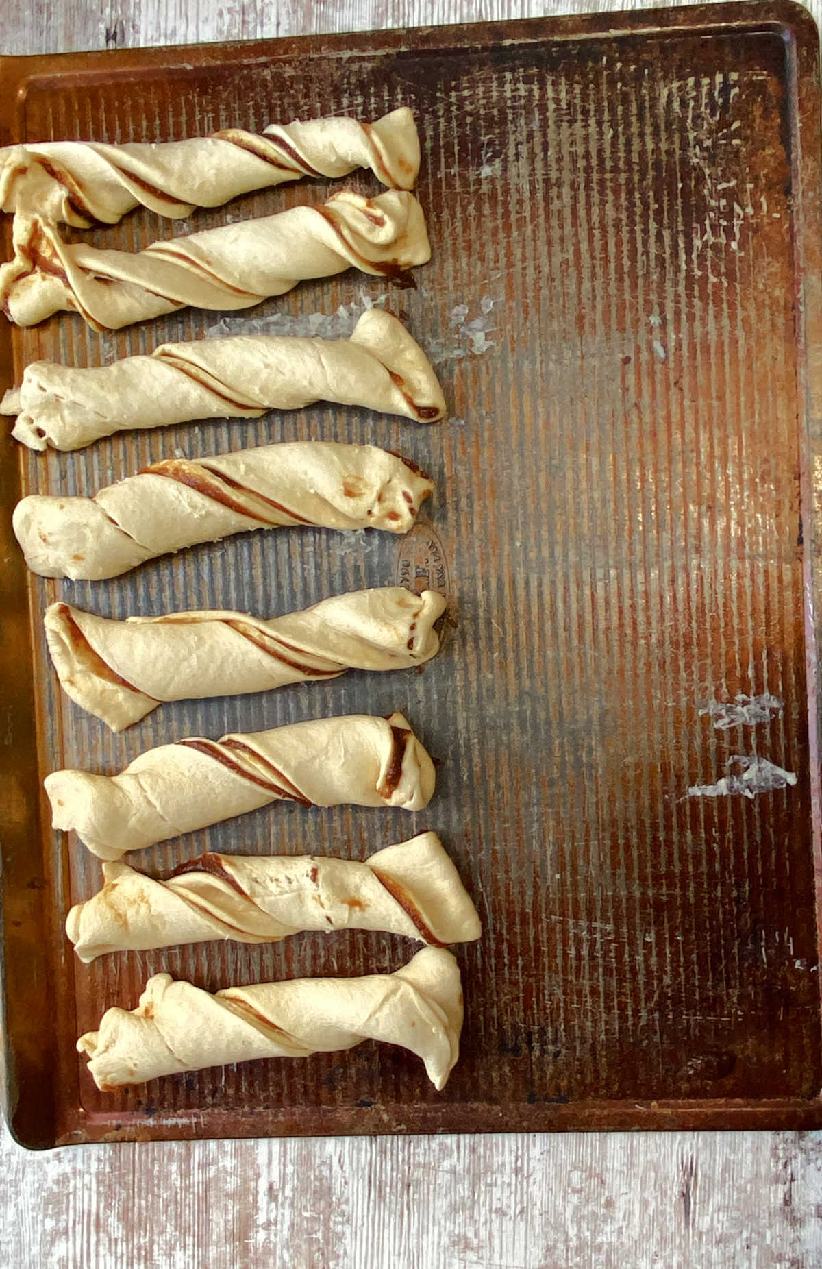 apple twists on a baking sheet, uncooked. 