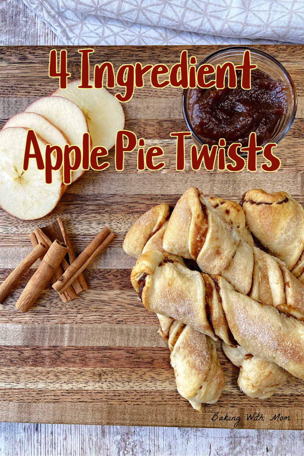 Apple pie twists on a brown cutting board with apple slices on top. 