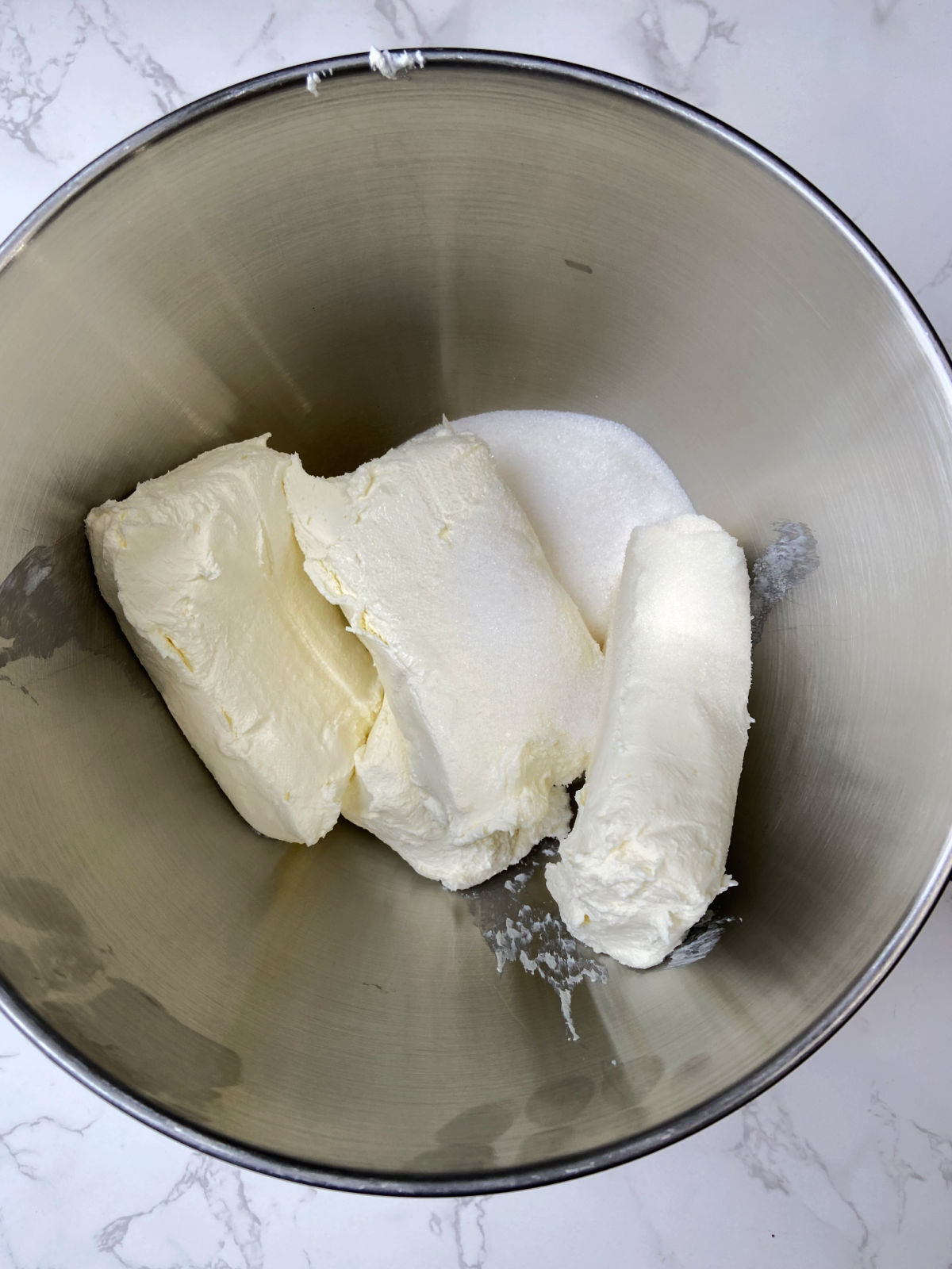 cream cheese and sugar in a bowl. 