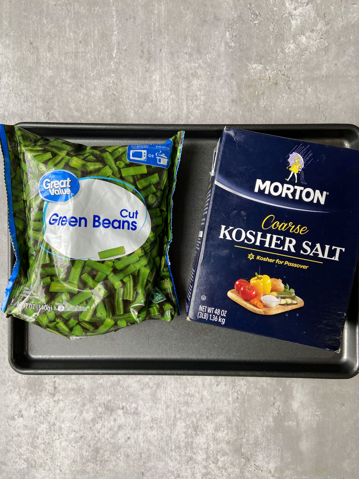 green bean bag and salt box on a baking sheet. 