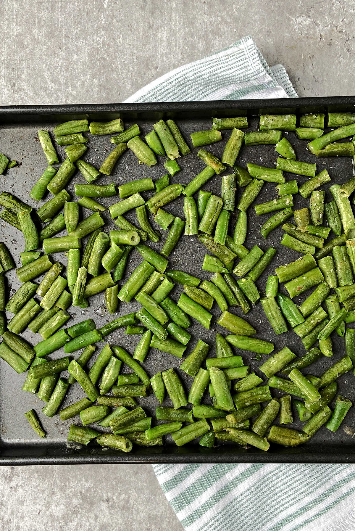 green beans on baking sheet with towel. 