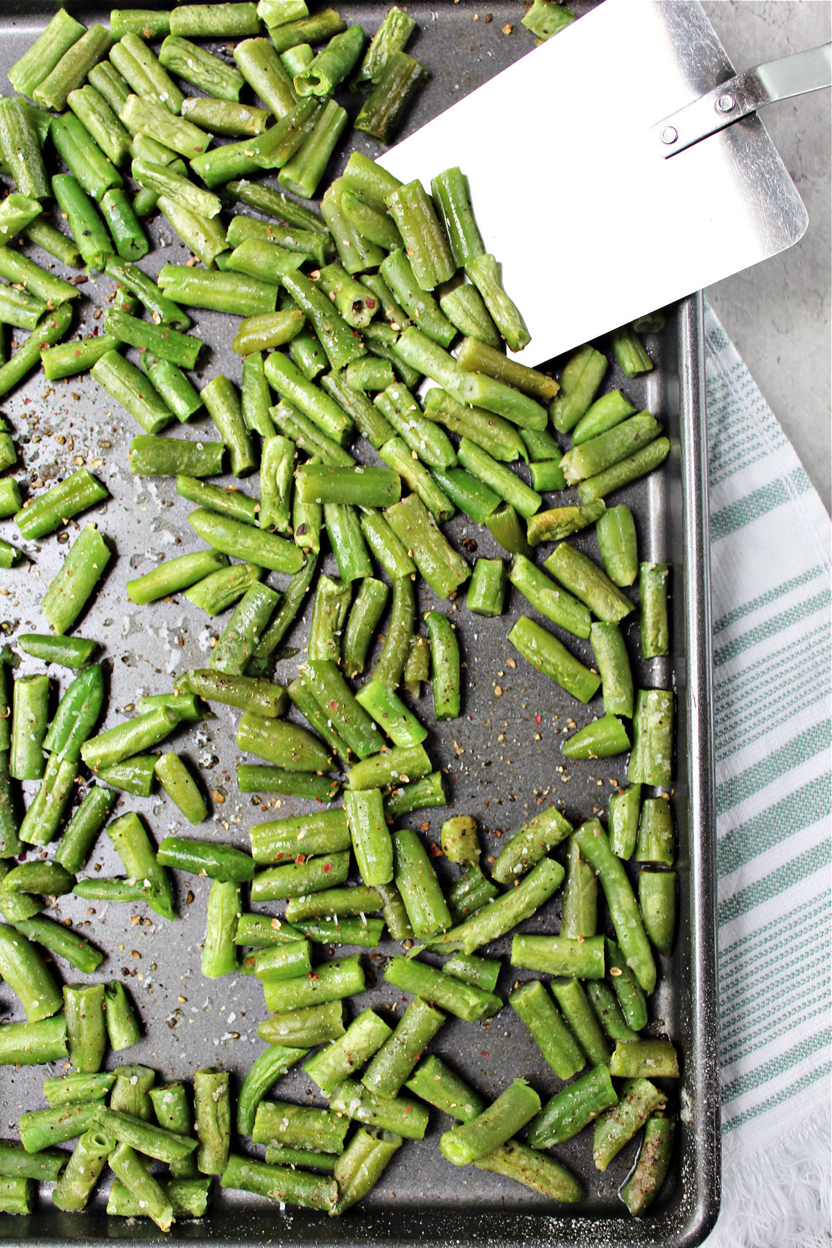 cooked green beans on a baking sheet.