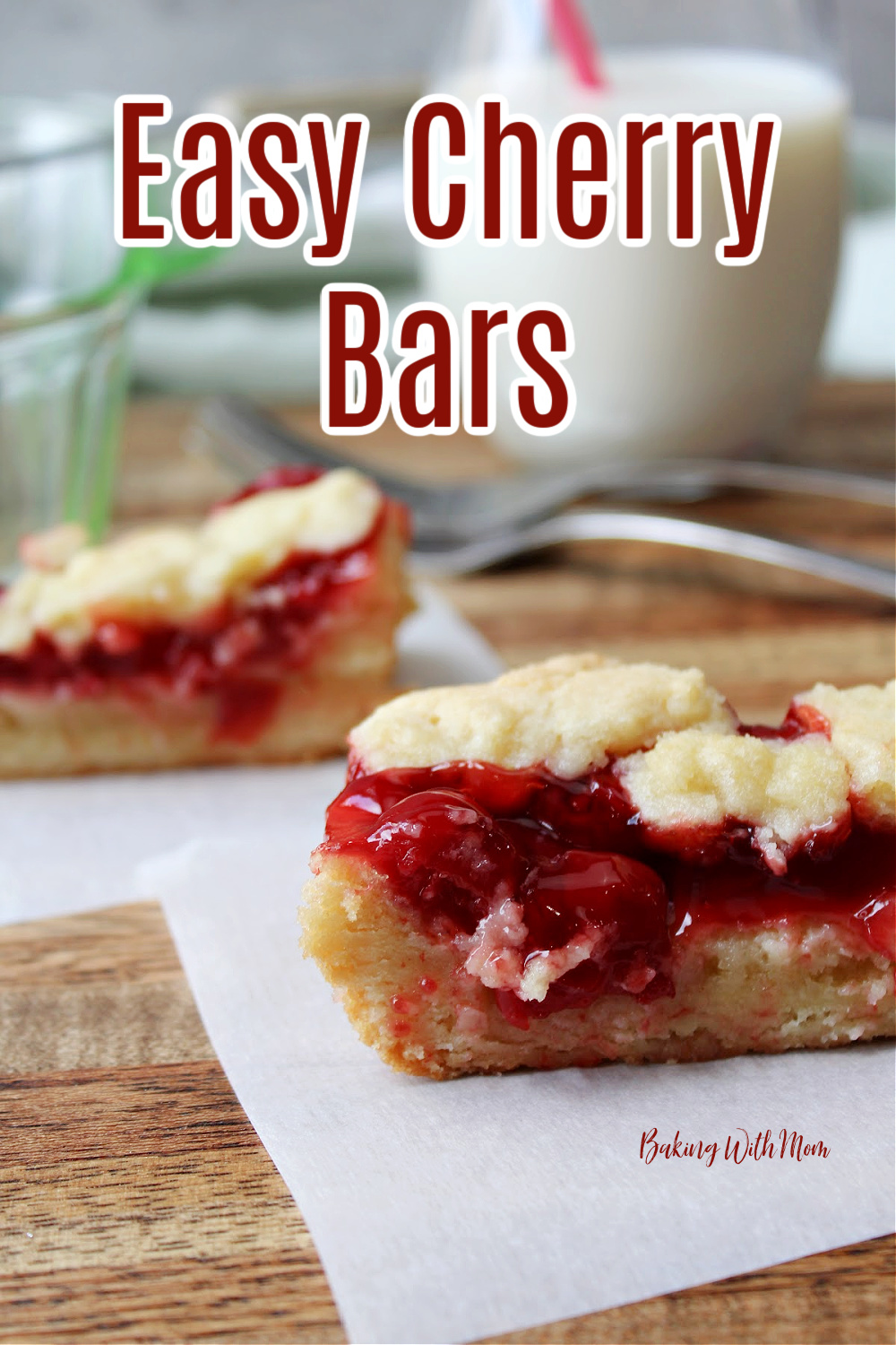 Cherry pie bars on parchment paper on a wooden cutting board. 
