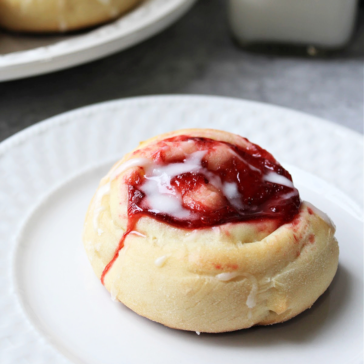 strawberry danish on a white plate.
