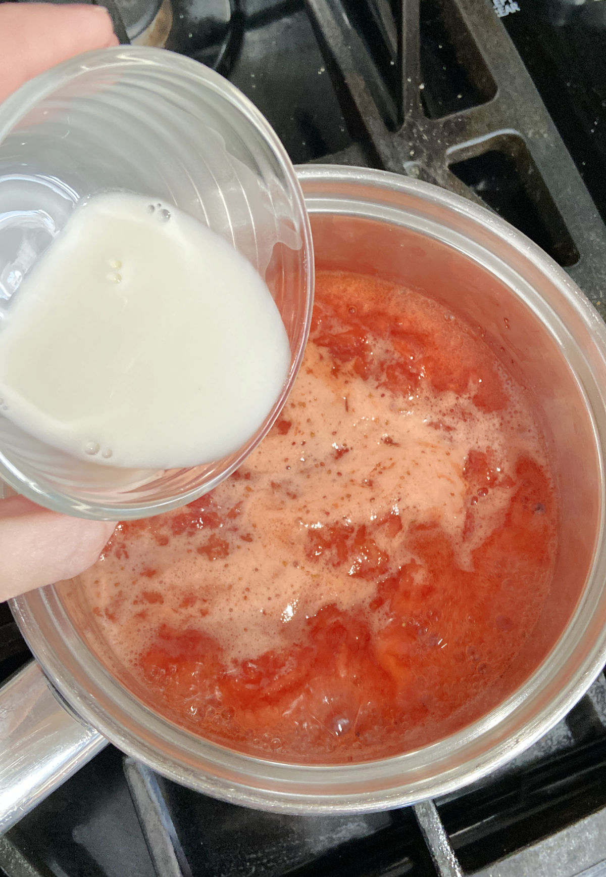 cornstarch in a clear glass and strawberry sauce in a pot. 