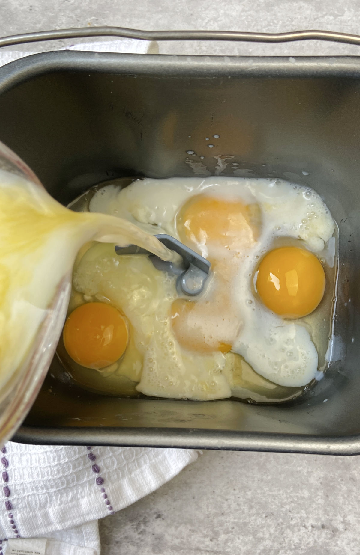 mik, eggs, butter in a bread machine bowl. 