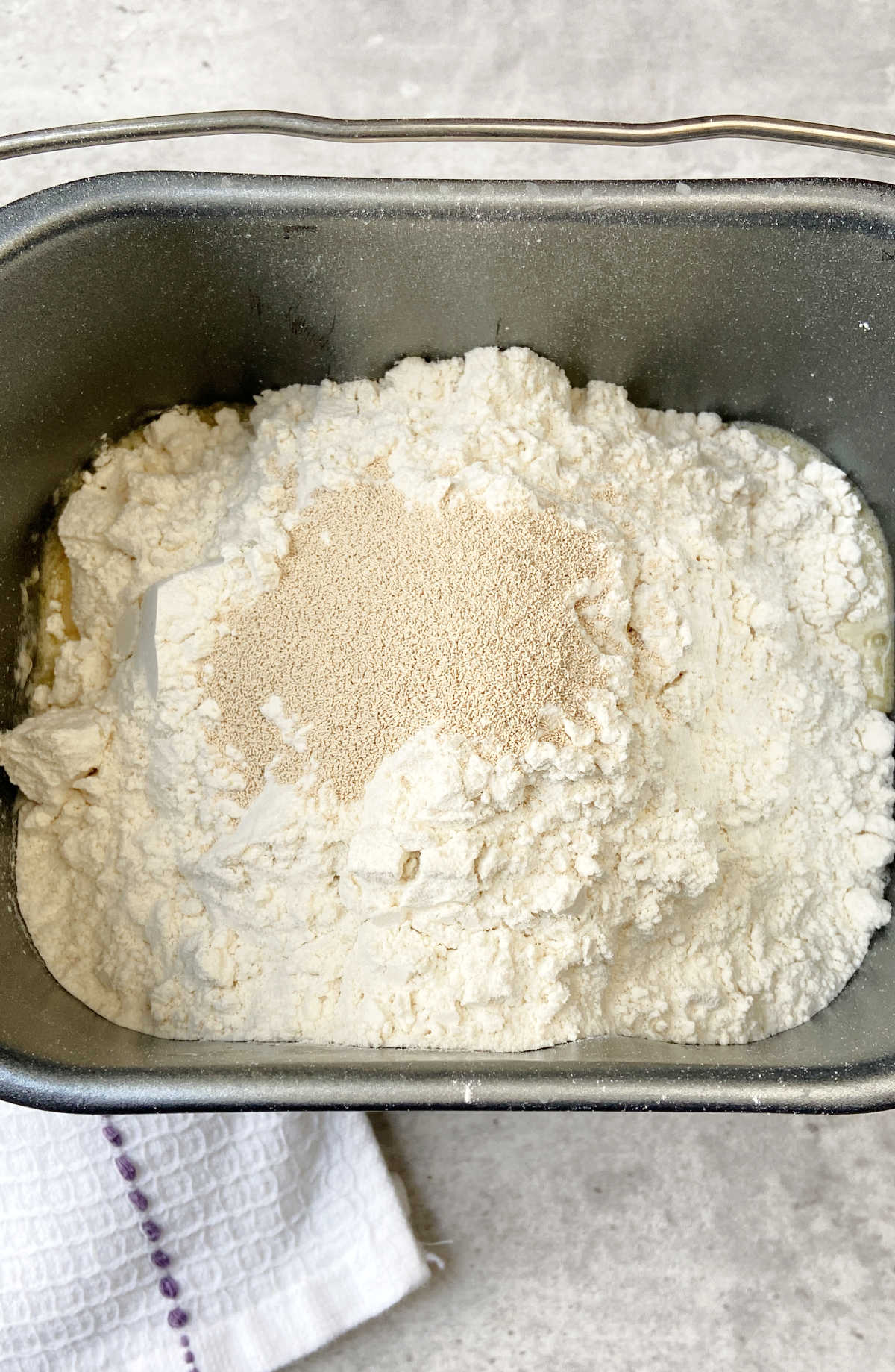 flour and yeast in a bread machine bowl. 