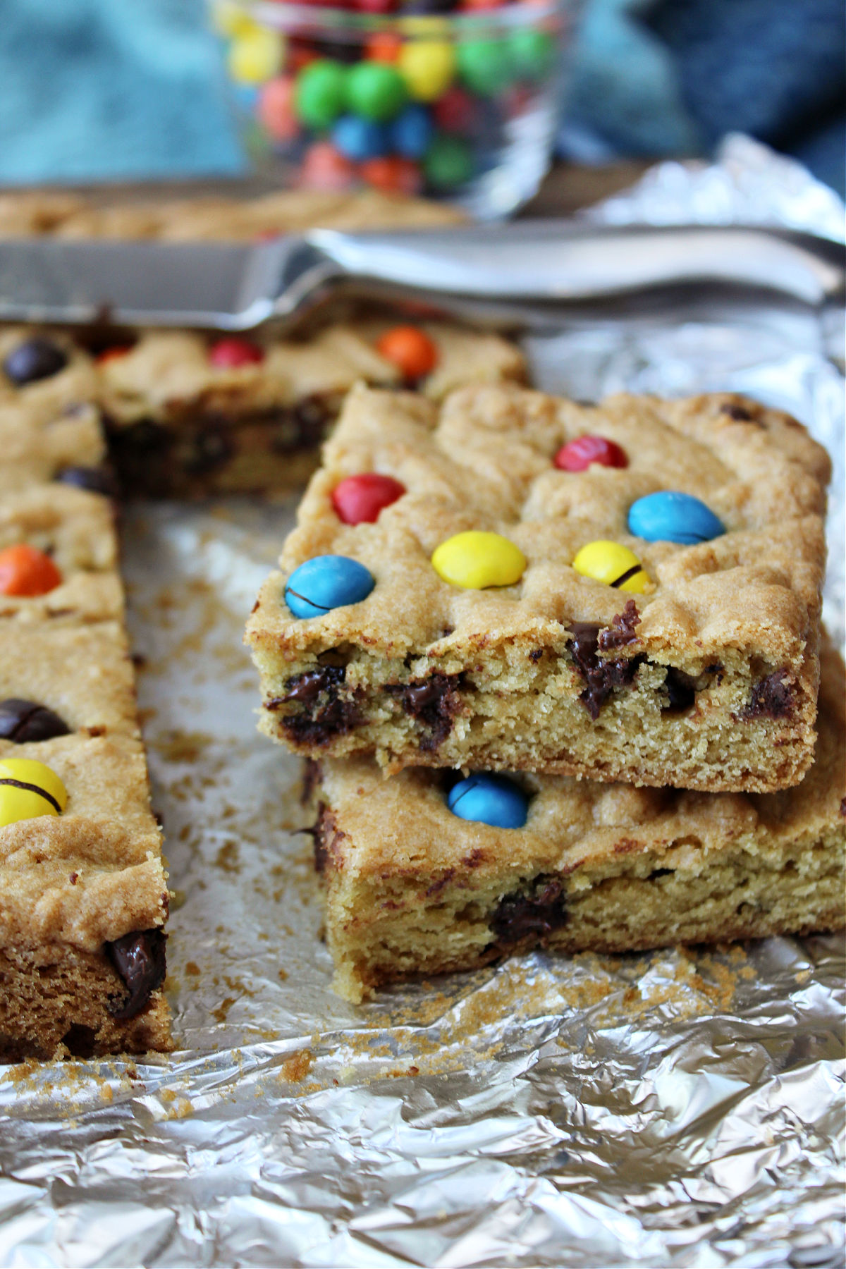 cookie bars on foil with mm behind. 