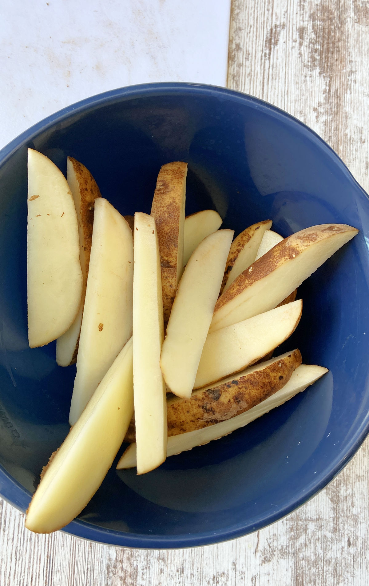 potato wedges in a blue bowl. 