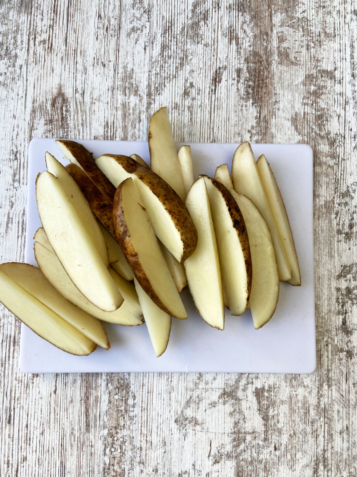 potato slices on a cutting board. 