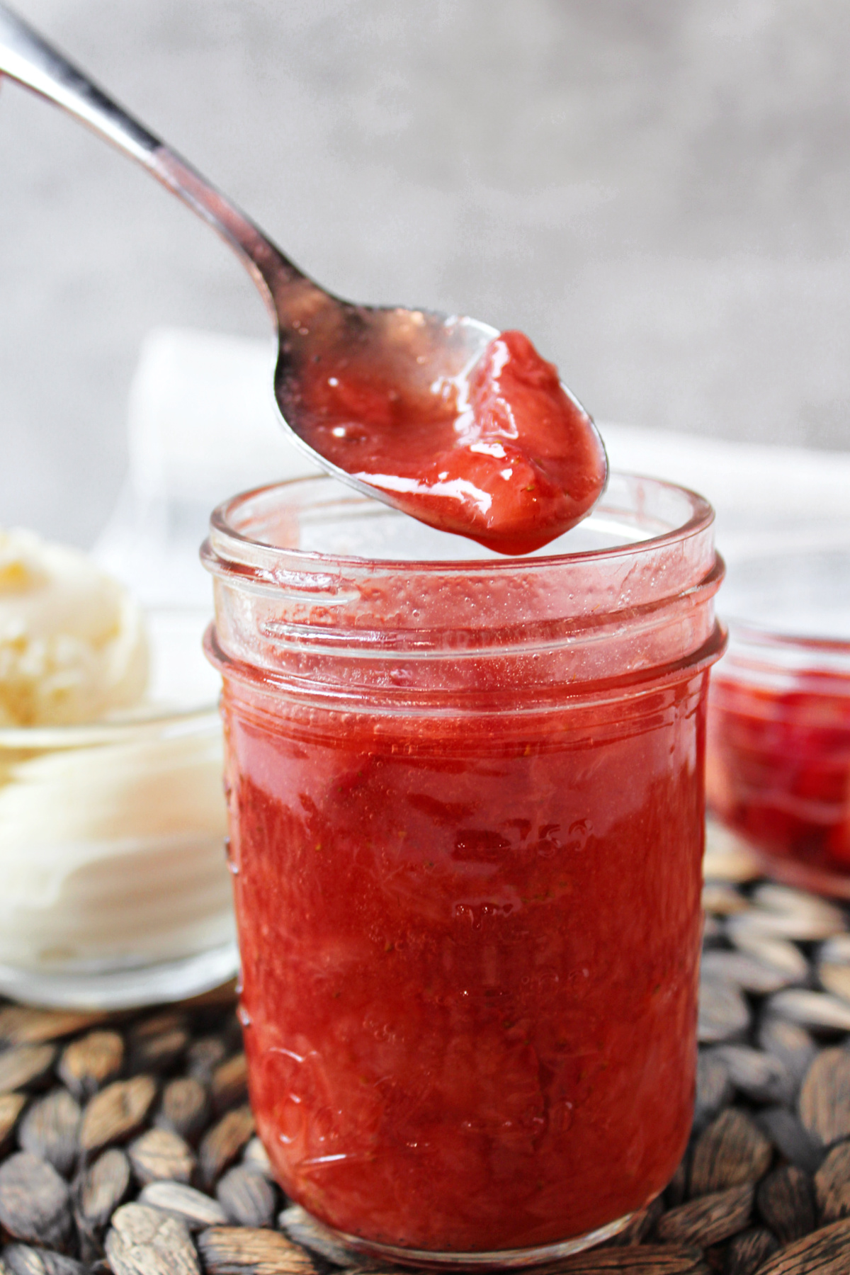 strawberry sauce in a jar with a spoon. 