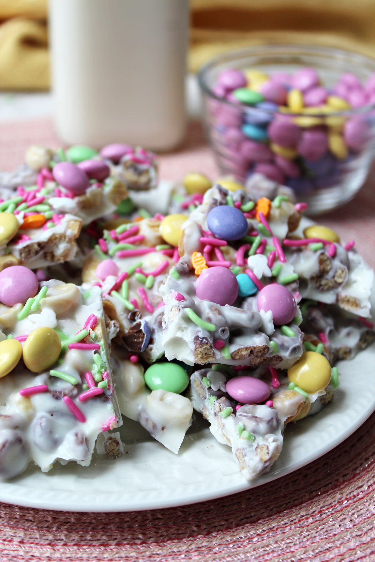 Bunny bark on a white plate with M&M's behind. 